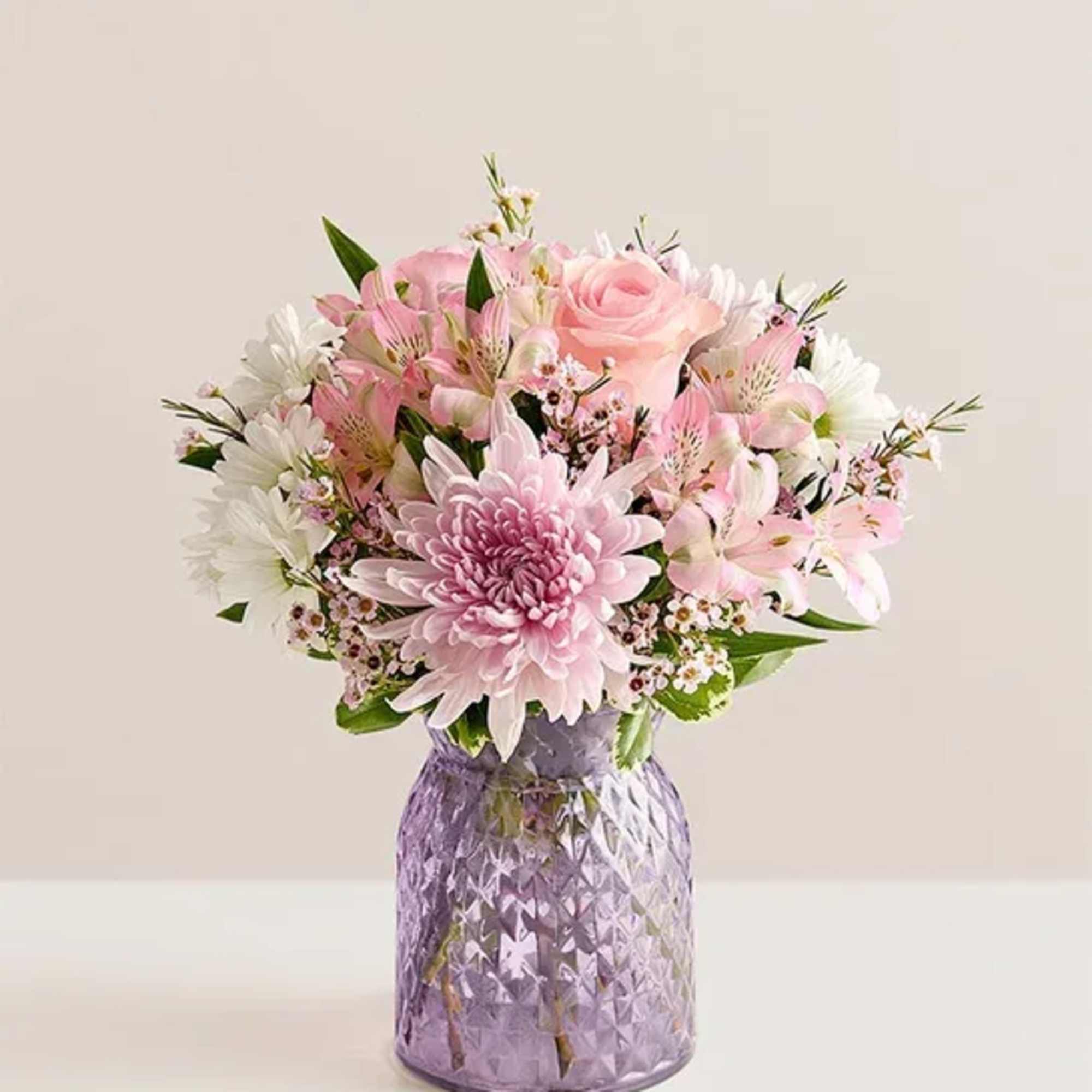 Soft pink roses and large pink chrysanthemums bloom together with pale pink