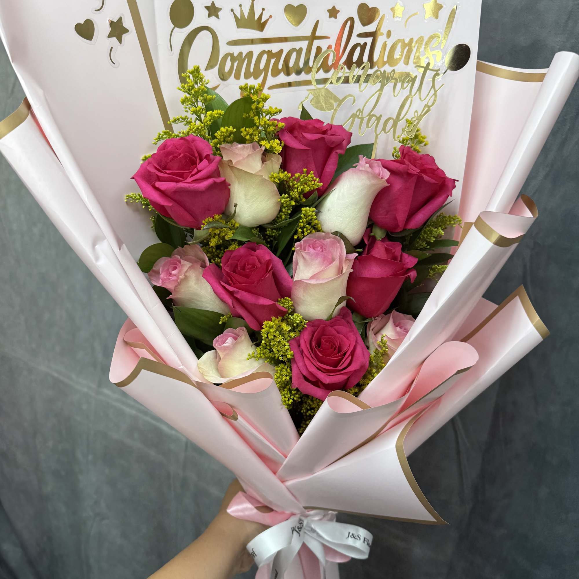 Mix pink  roses with fillers and greenery, wrapped in pale pink