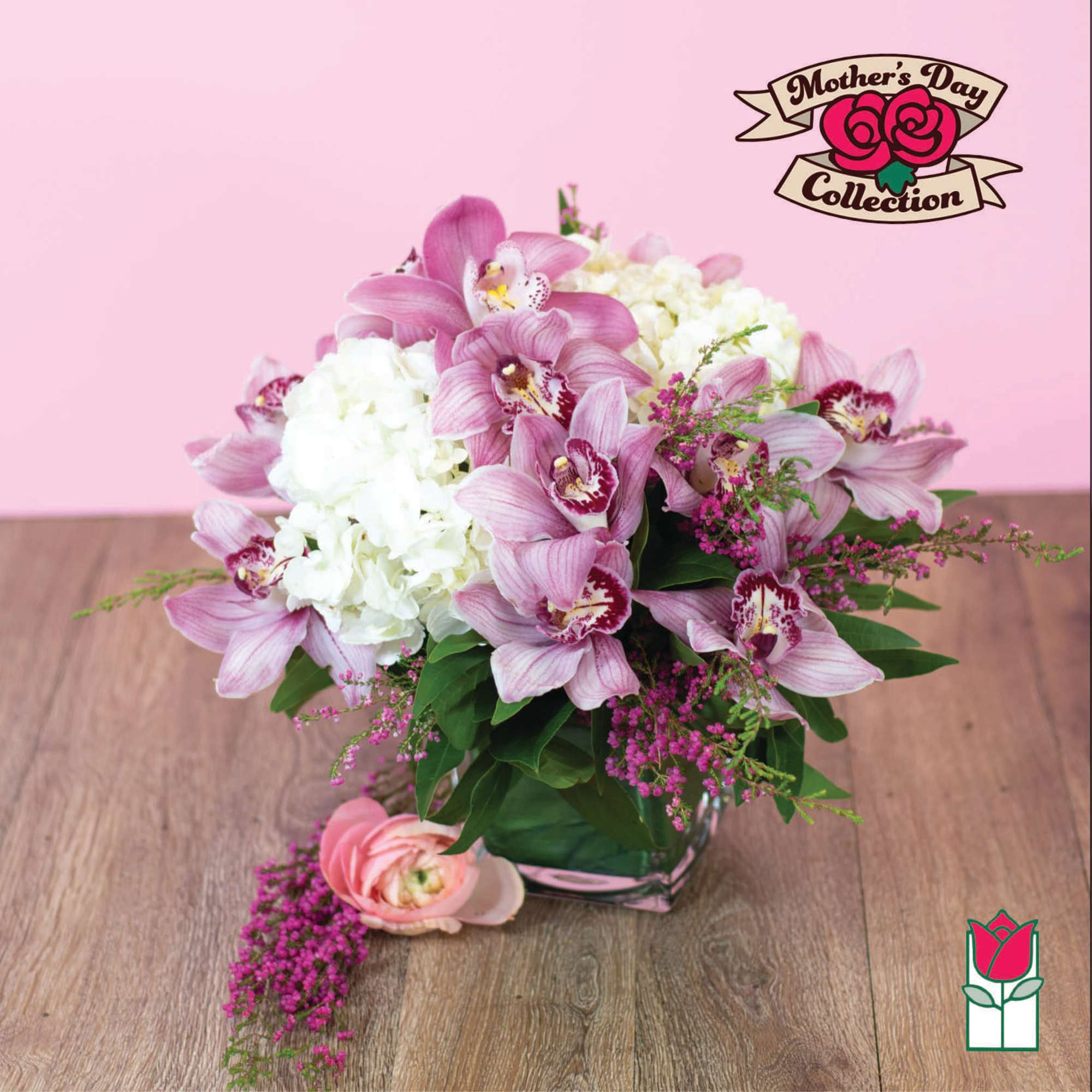 Pink orchids and white hydrangea in a glass vase on a wooden table