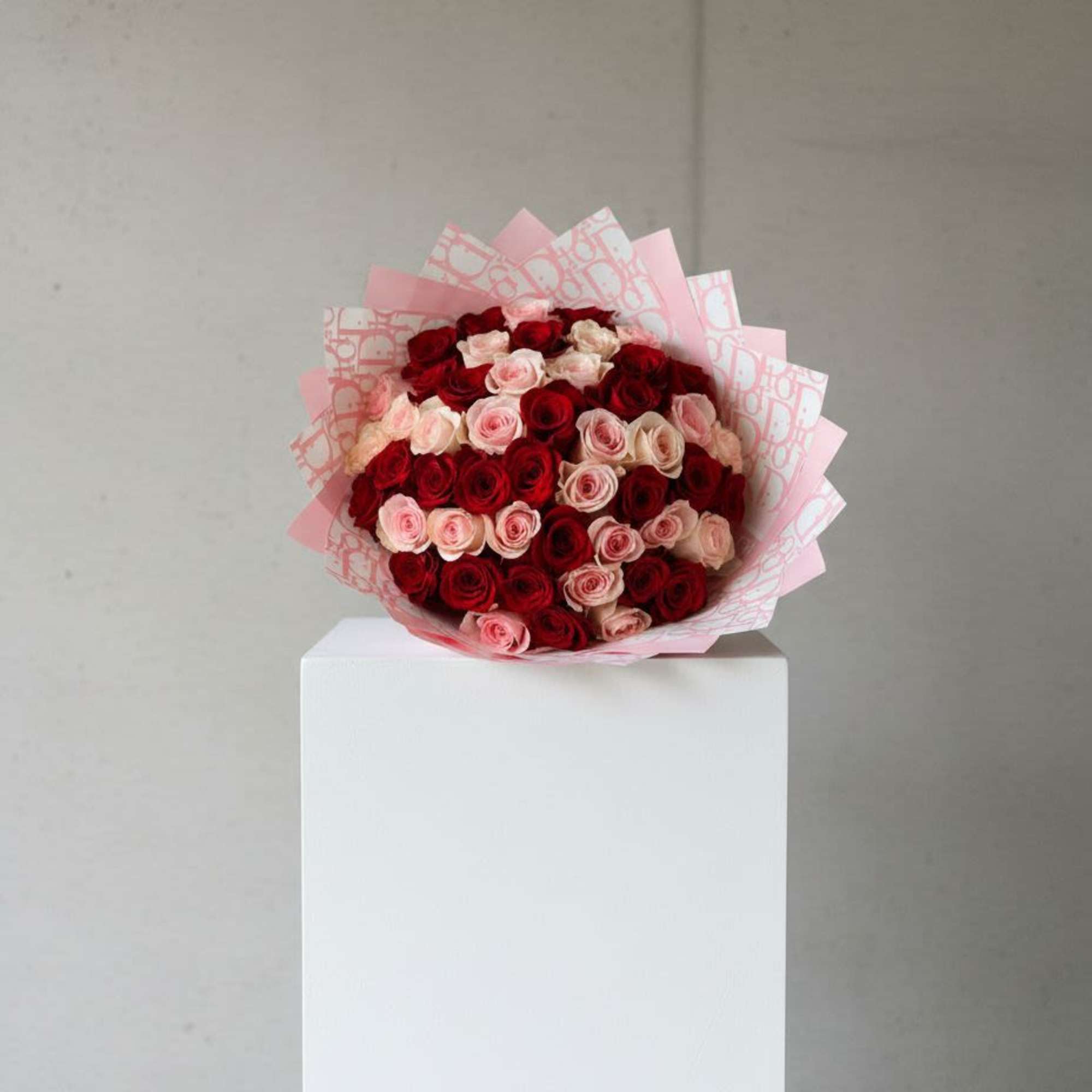 Bouquet of red and pink roses wrapped in pink paper