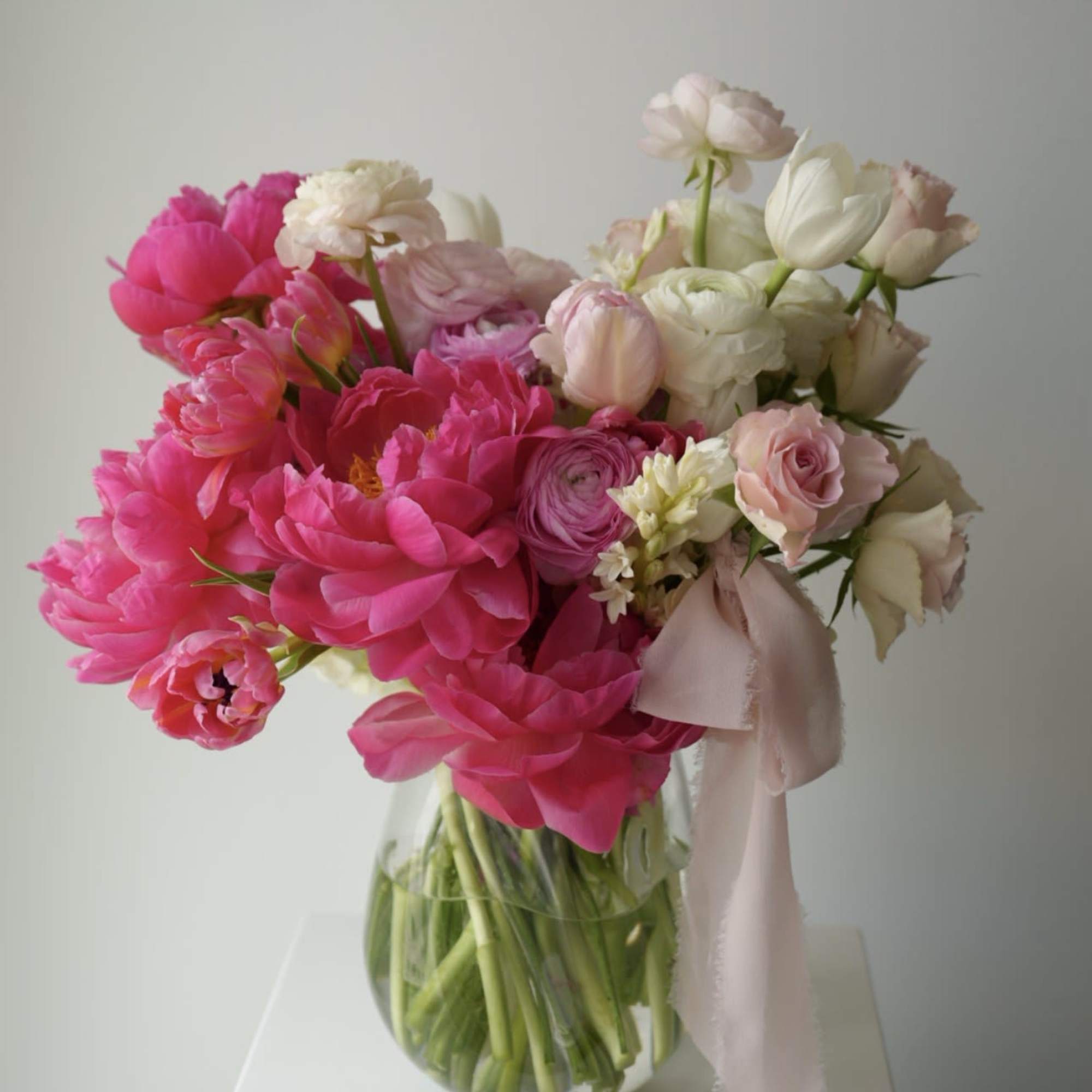A soft and romantic spring arrangement in layered shades of blush pink