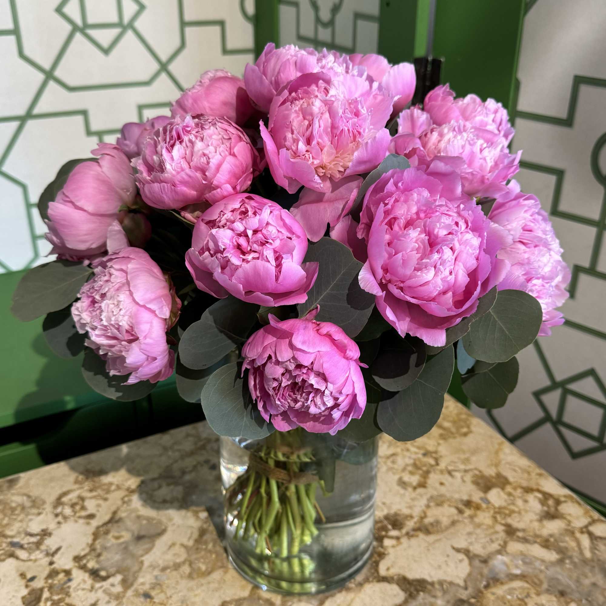 Pink peonies arranged in a clear glass vase