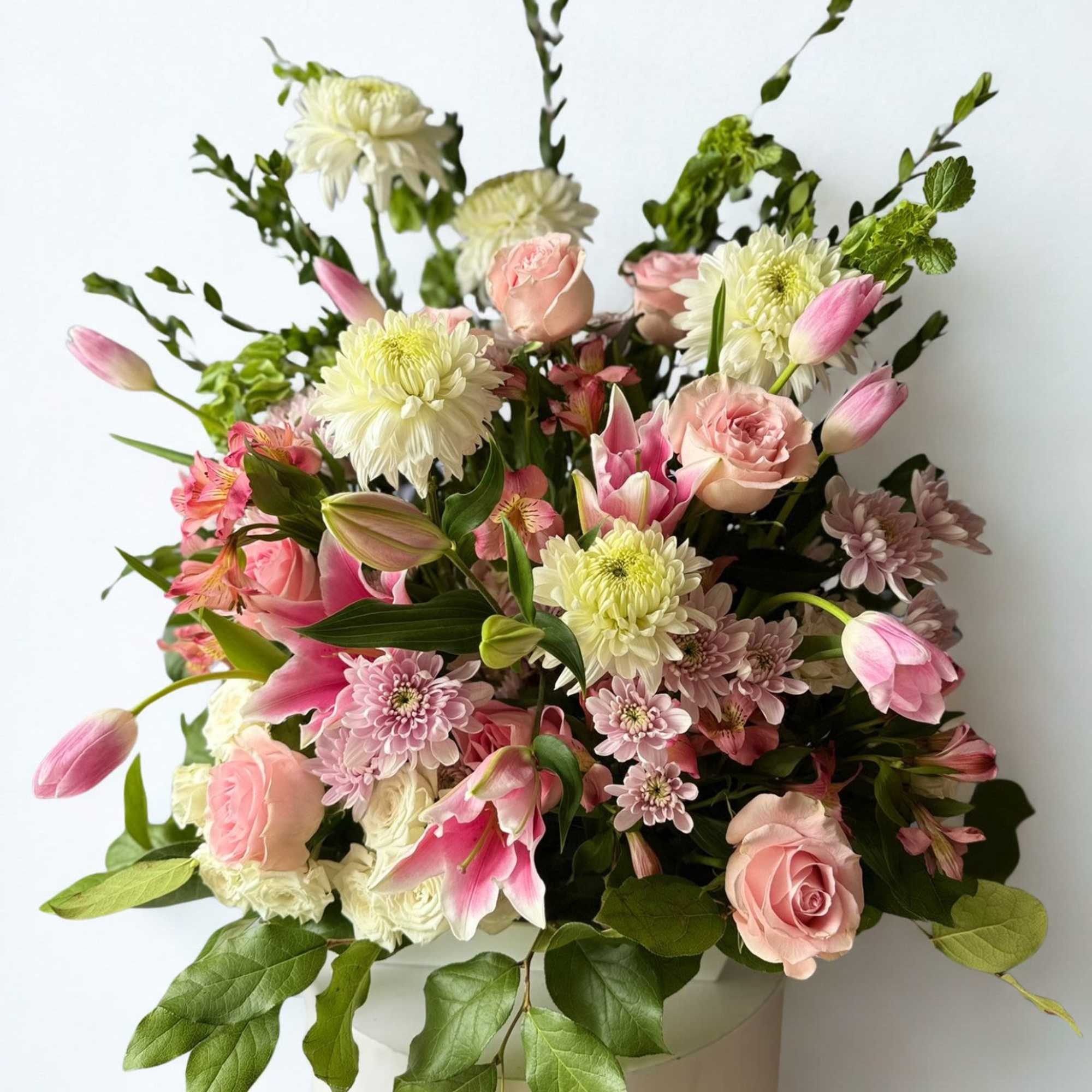 This pink and white funeral basket is a lovely sendoff and tribute.