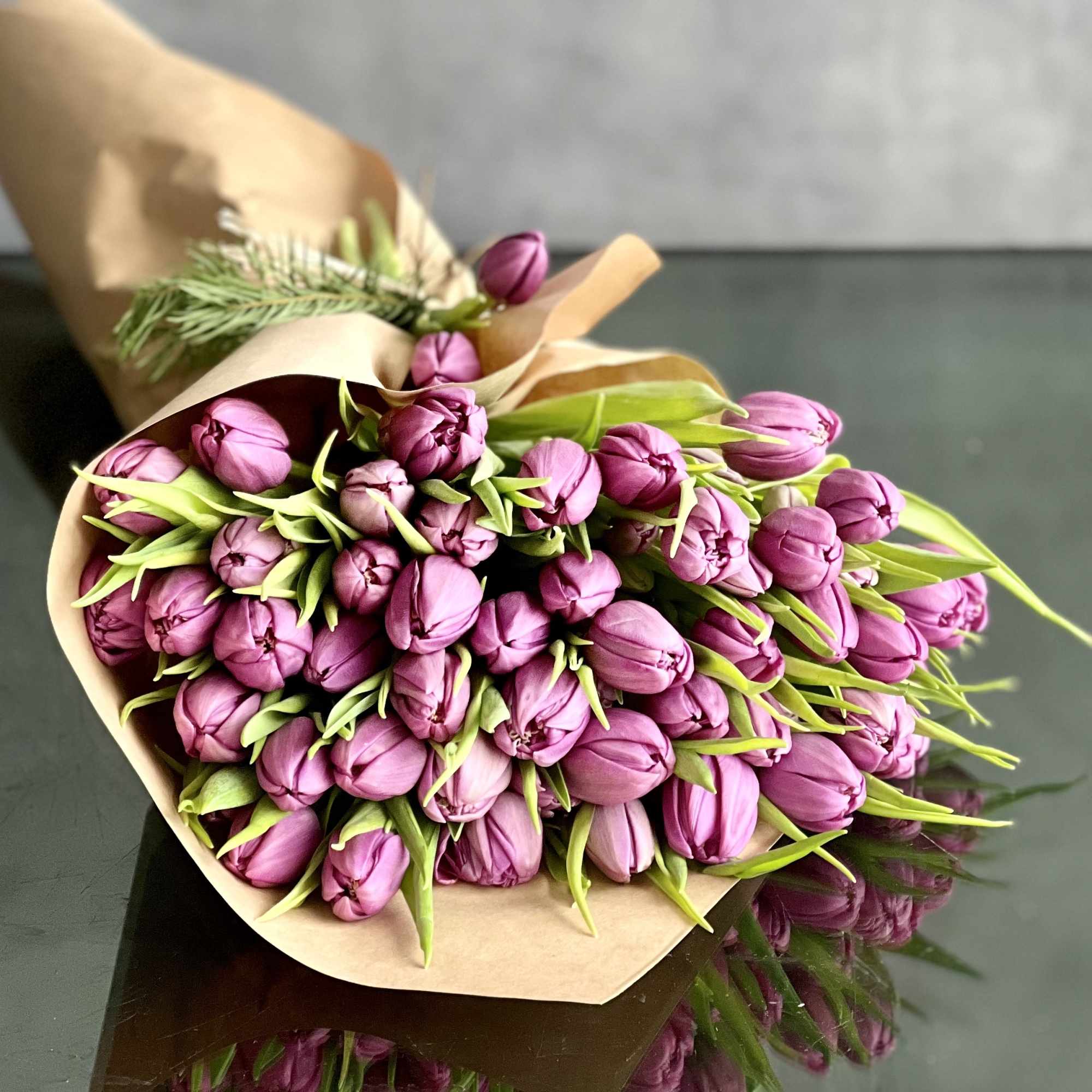 Bouquet of purple tulips wrapped in brown paper