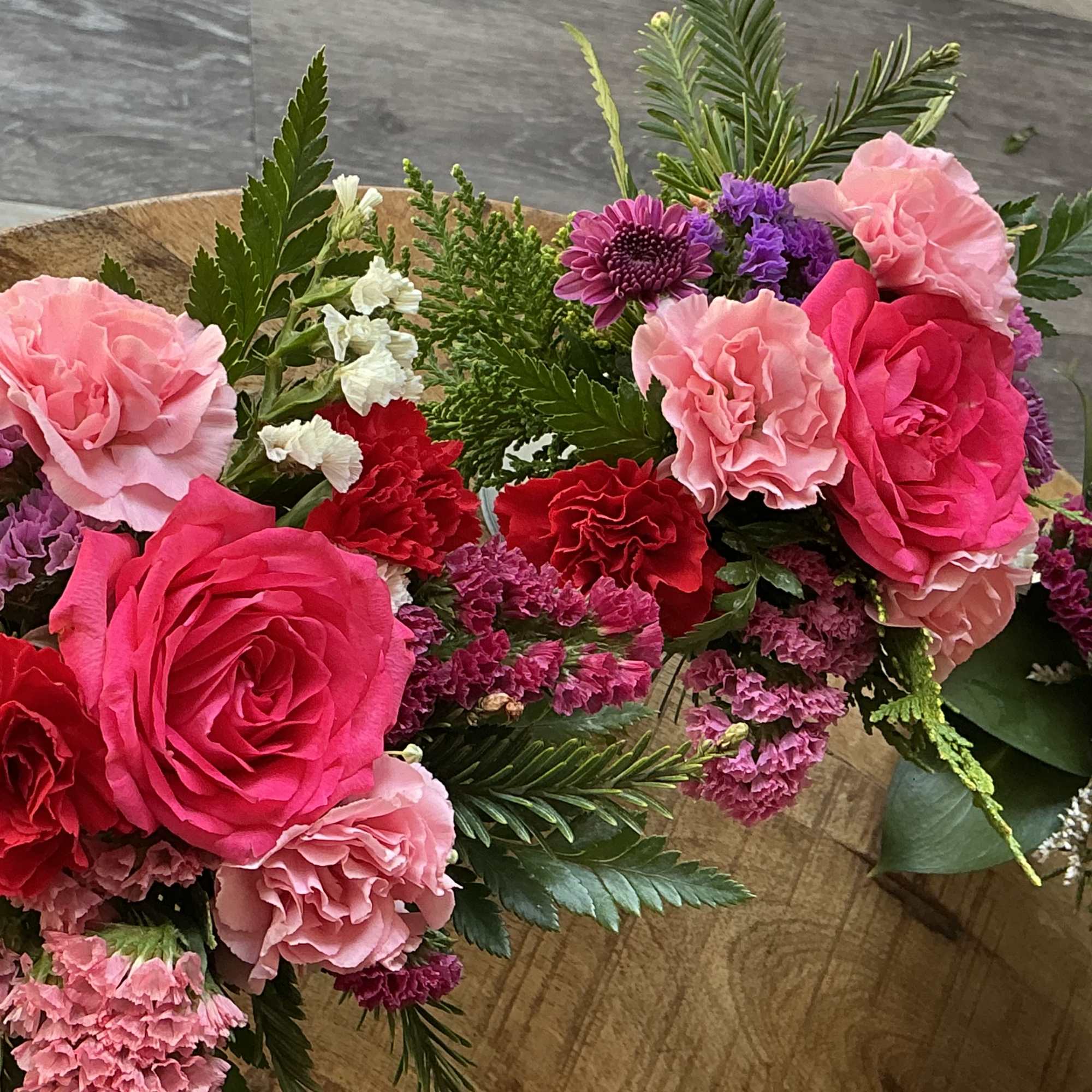 Pink and red rose bouquets with carnations and purple filler flowers