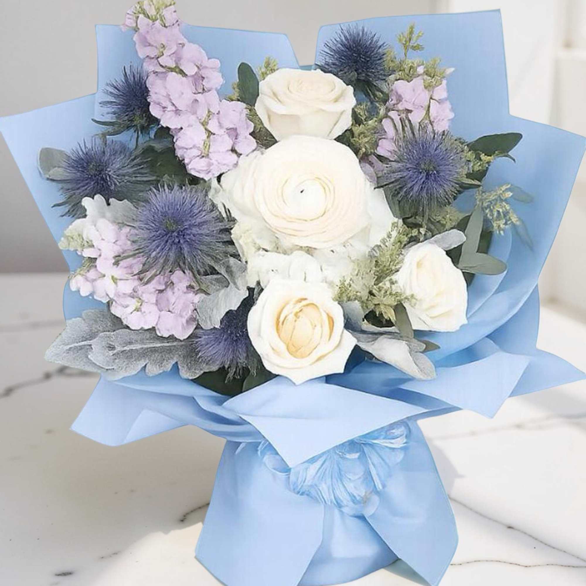 A beautiful hand-wrapped inspired by Columbia&rsquo;s signature blue, featuring elegant white roses
