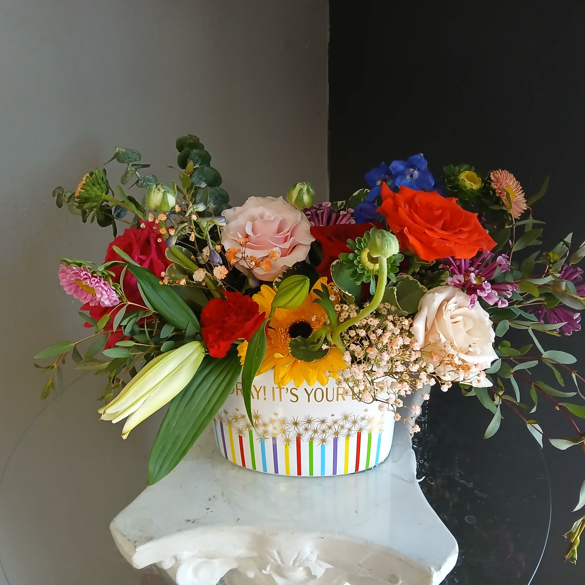 This beautiful flower arrangement of fresh mixed seasonal blooms is made by