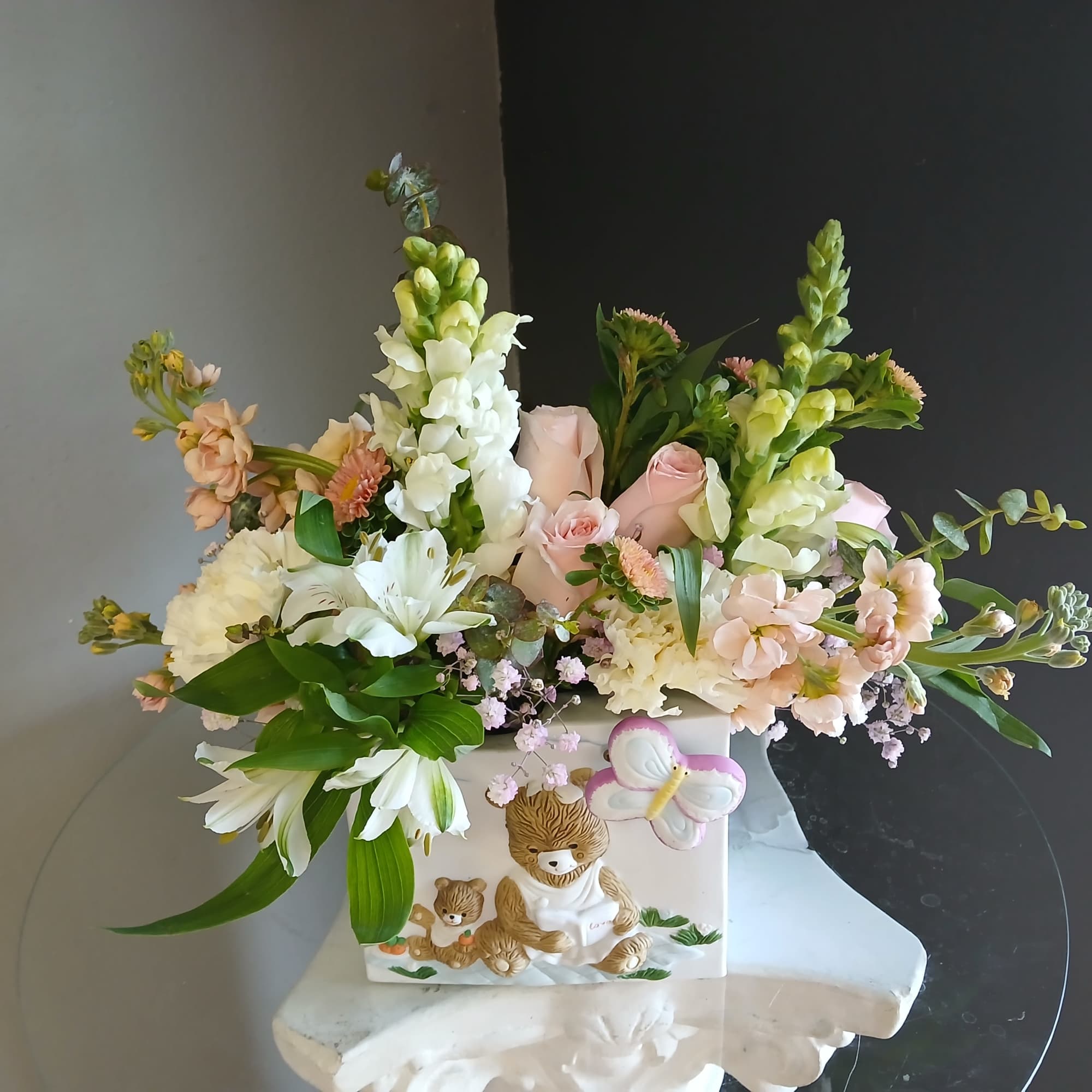 This beautiful flower arrangement of fresh mixed seasonal blooms is made by