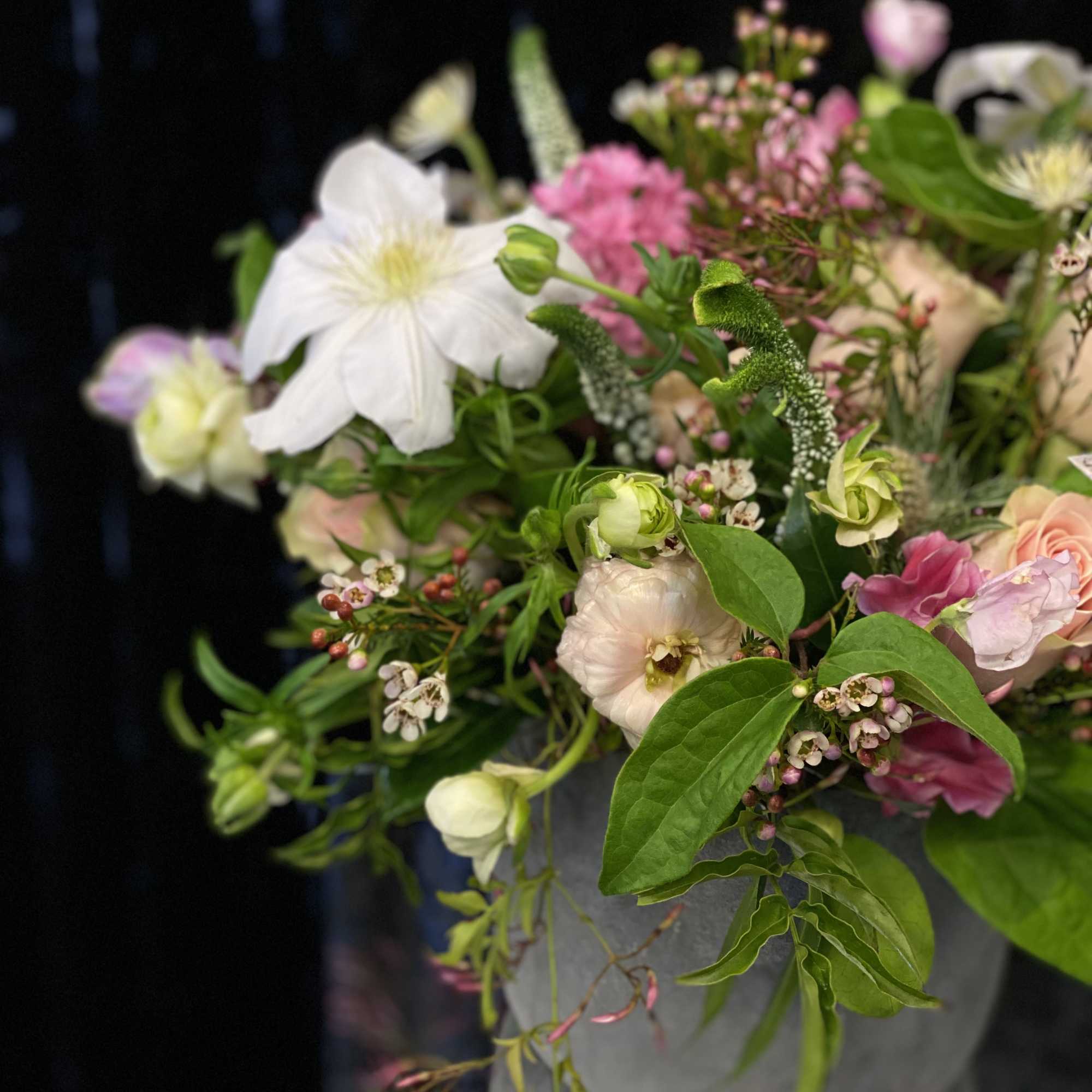 Mixed pink and white bouquet in a gray container