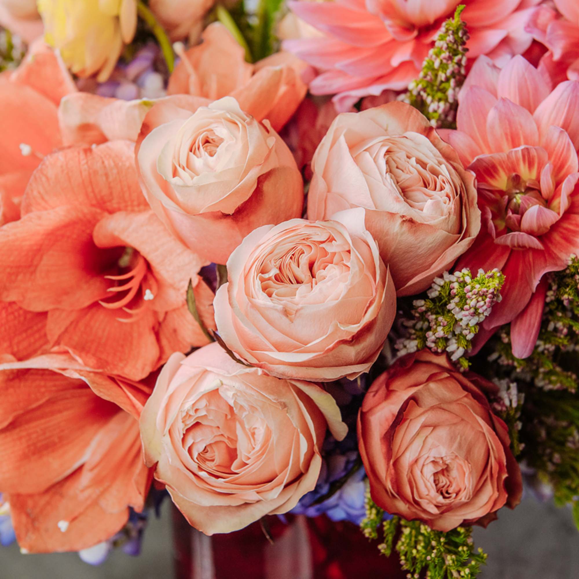 Peach roses and coral dahlias in a mixed bouquet