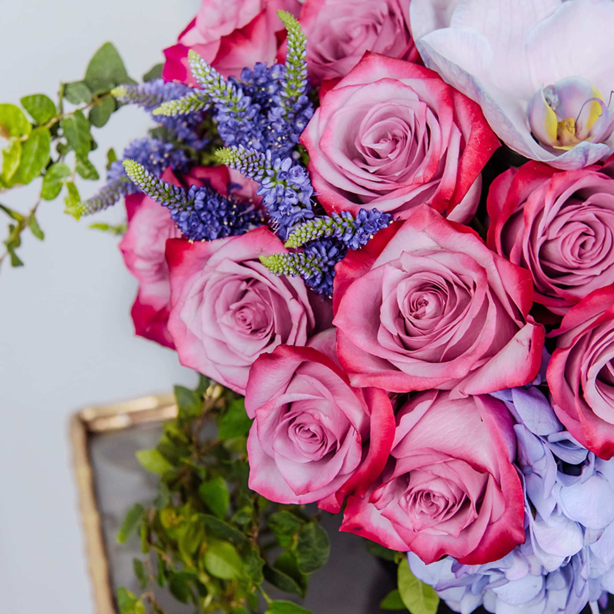 Bouquet of pink roses with purple flowers and pale hydrangea