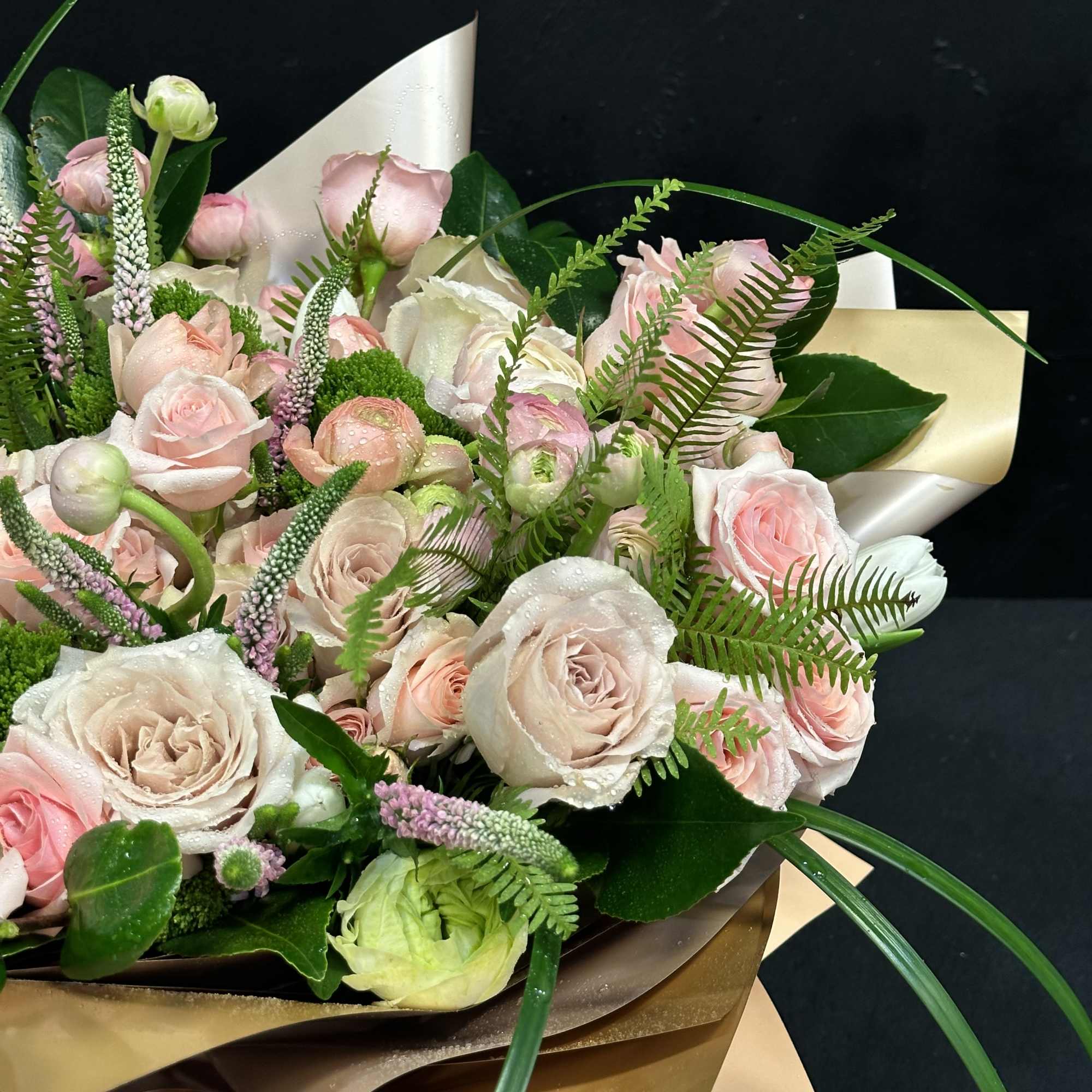 Bouquet of pale pink and cream roses with green accents