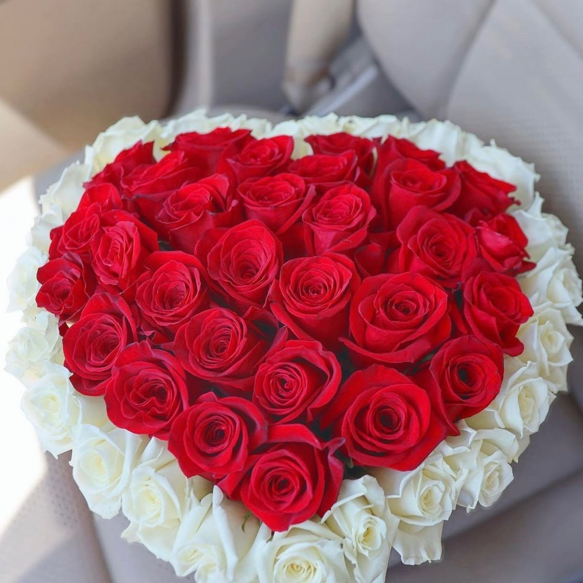 Heart-shaped bouquet of red and white roses