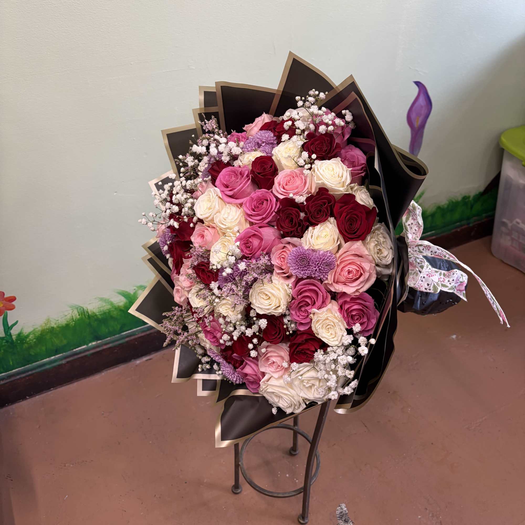 Large bouquet of pink, red, and white roses with baby's breath