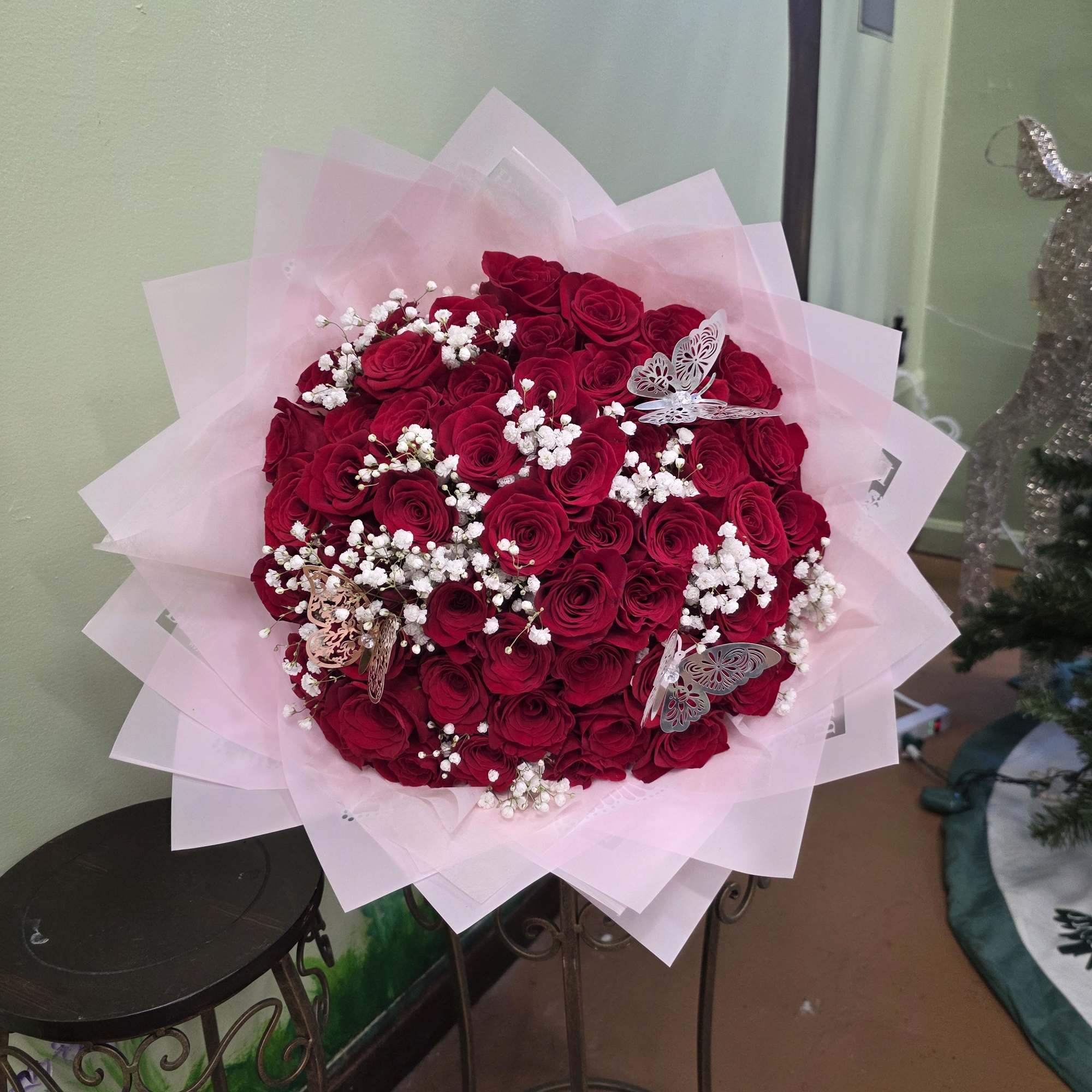 Bouquet of red roses with white baby's breath in pink wrap