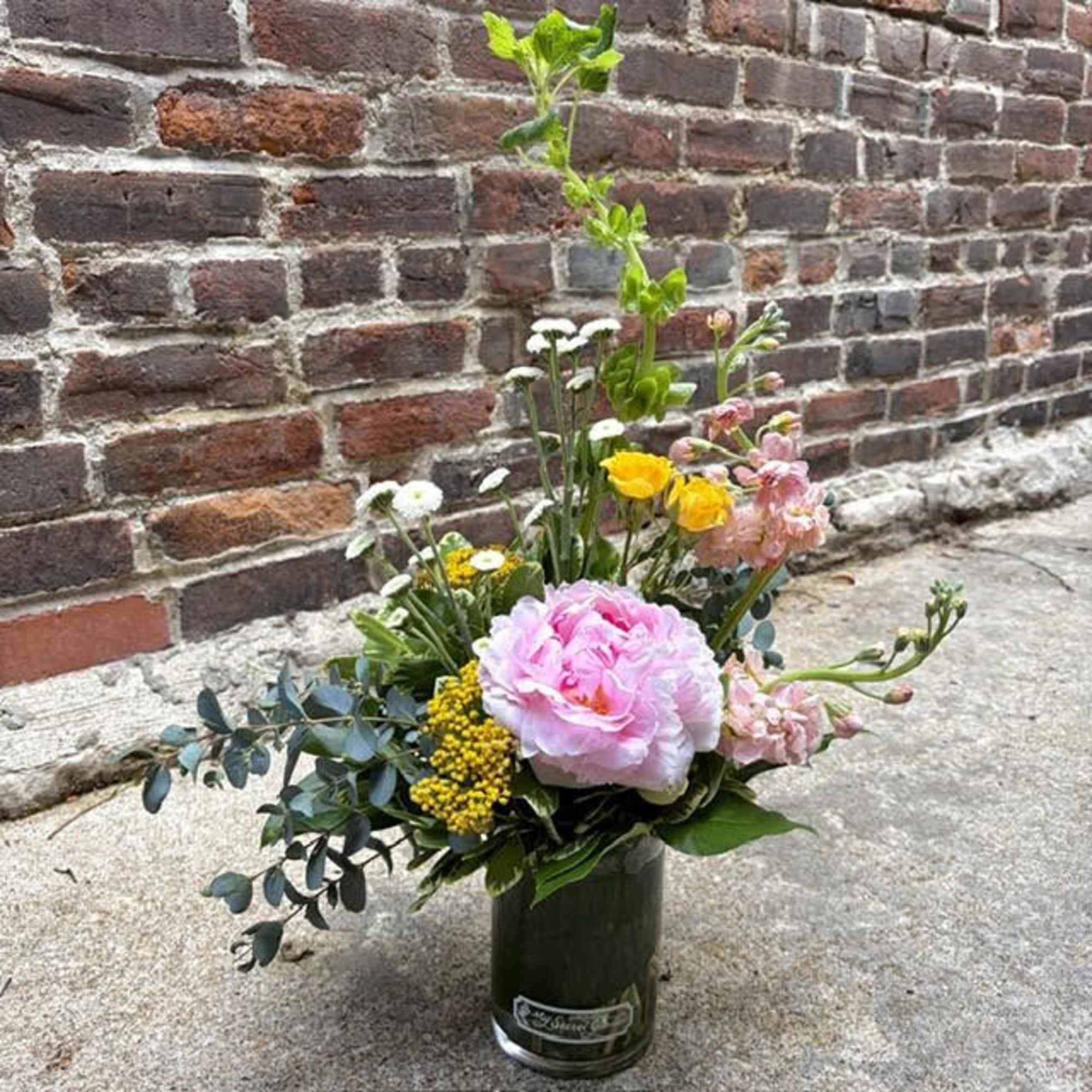 A single large blush-pink peony anchors this Modern Peony flower arrangement, giving