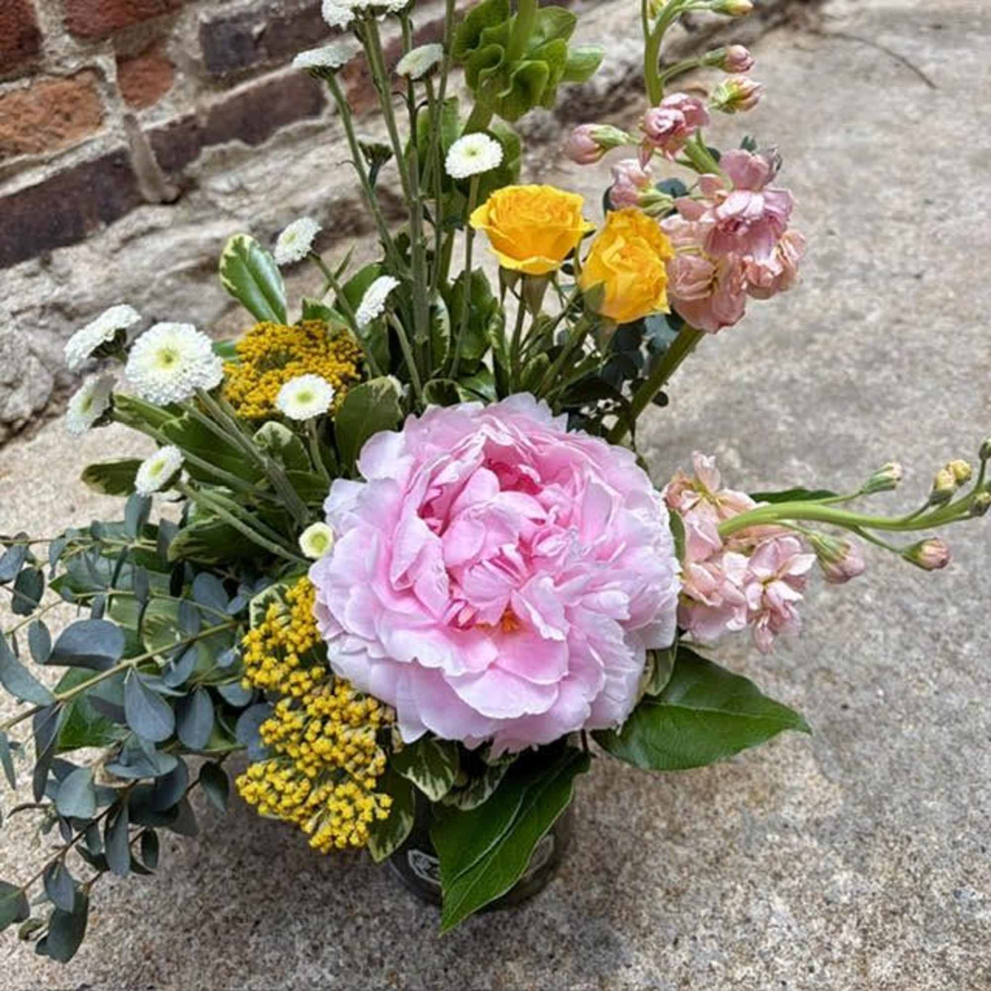 A single large blush-pink peony anchors this Modern Peony flower arrangement, giving