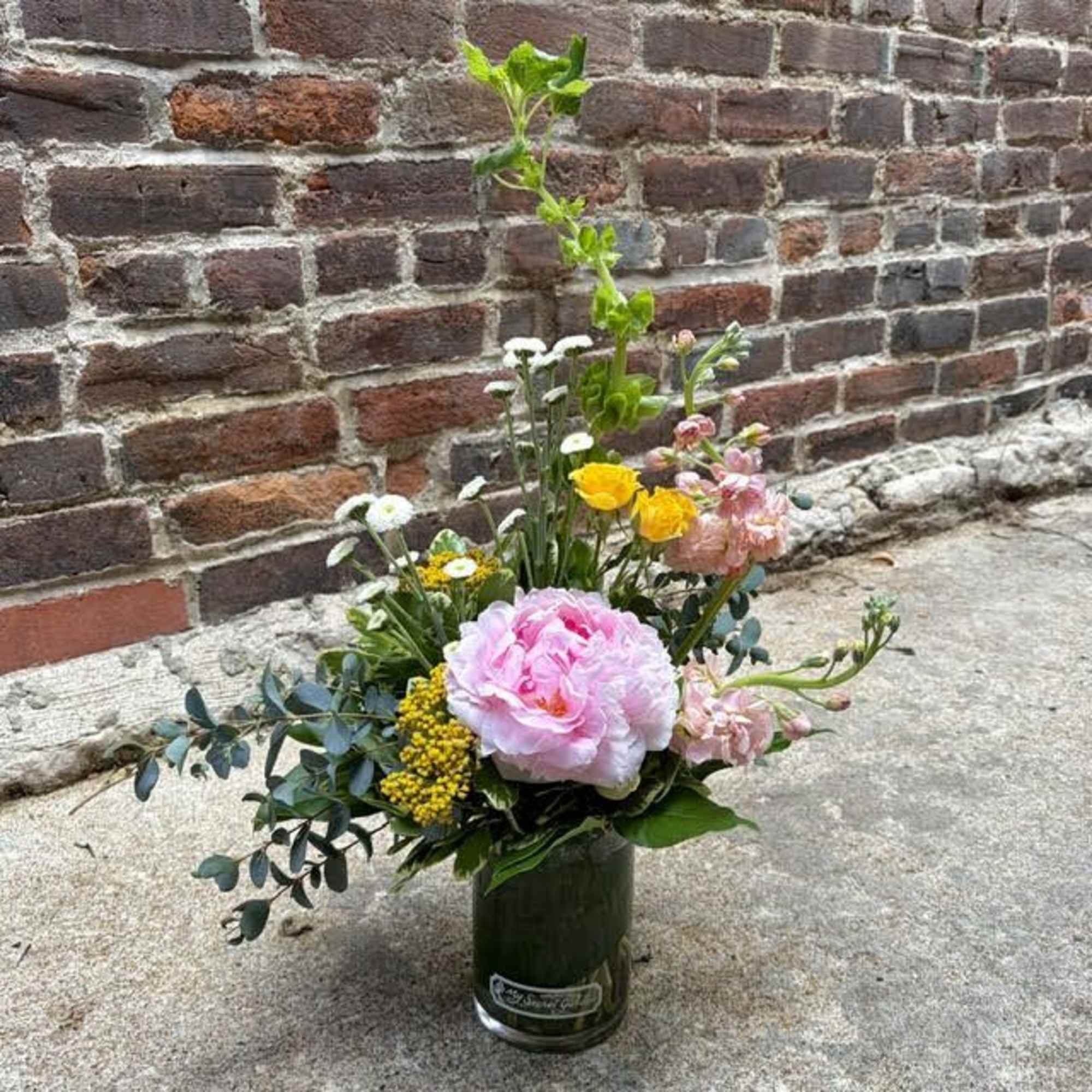 A single large blush-pink peony anchors this Modern Peony flower arrangement, giving