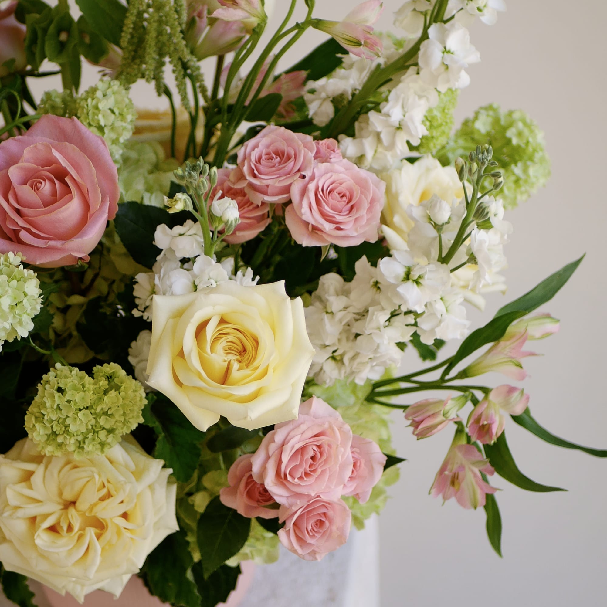 Pink and cream garden roses are the focal point of this garden-style