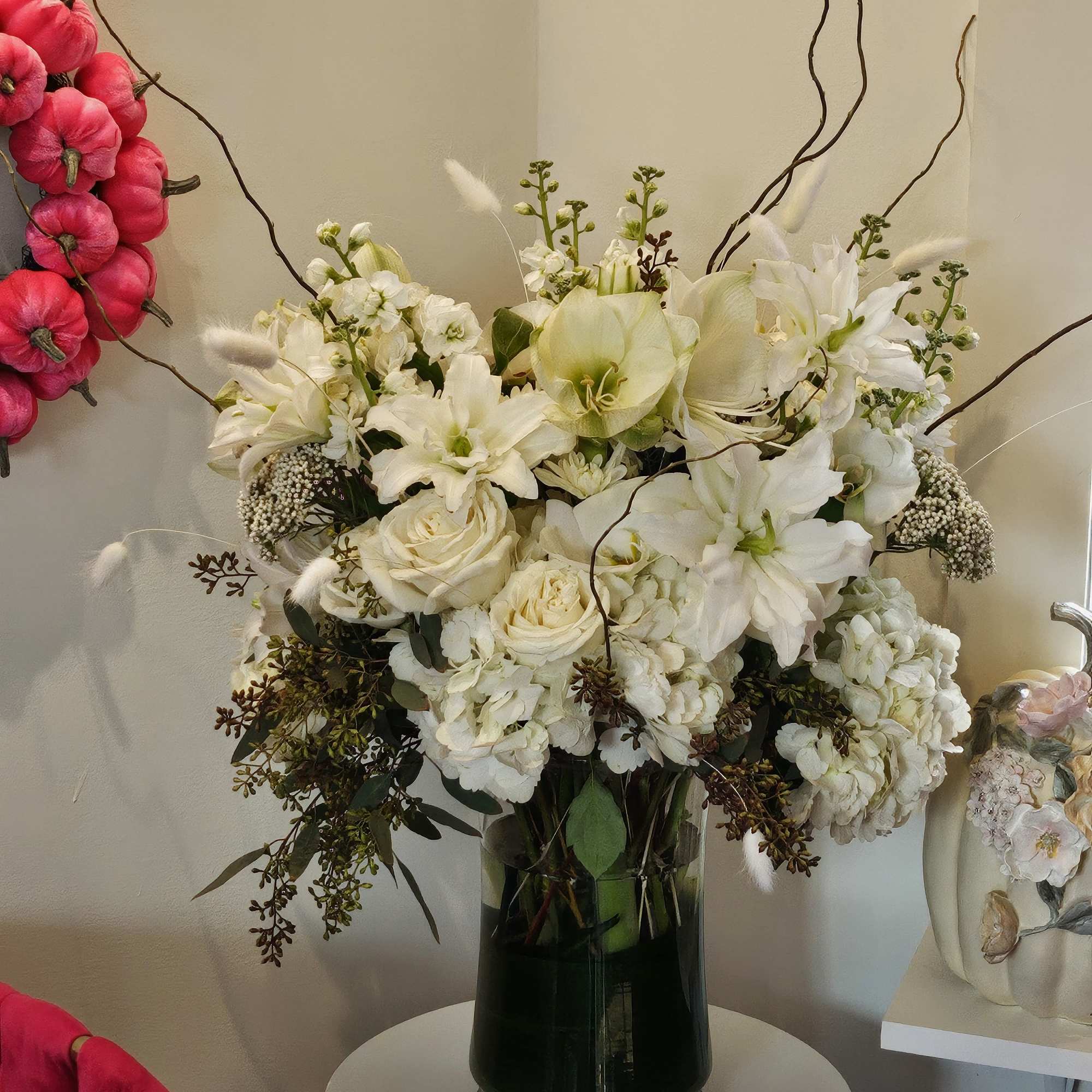 White floral arrangement in a dark glass vase
