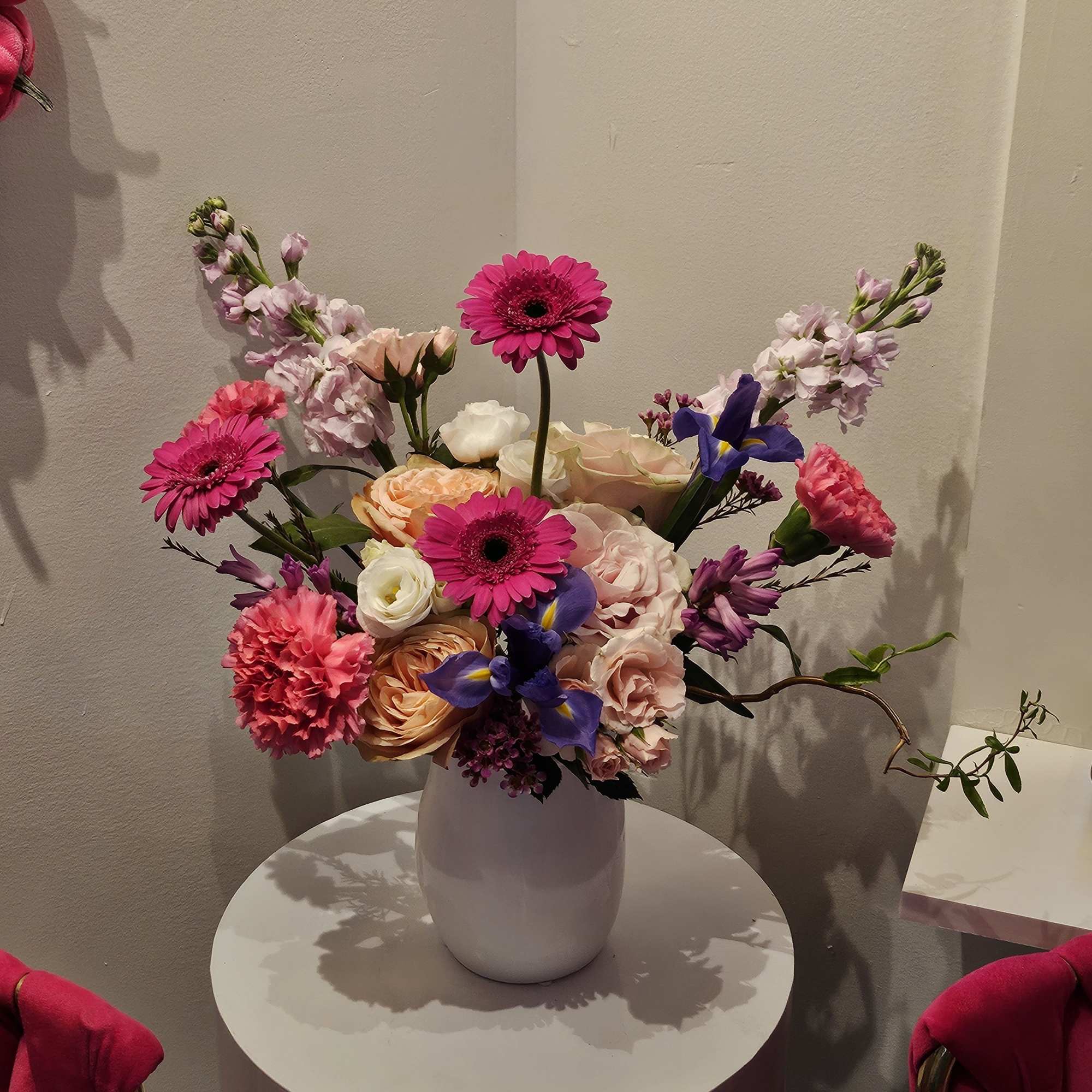 Colorful bouquet in a white vase with pink and purple blooms