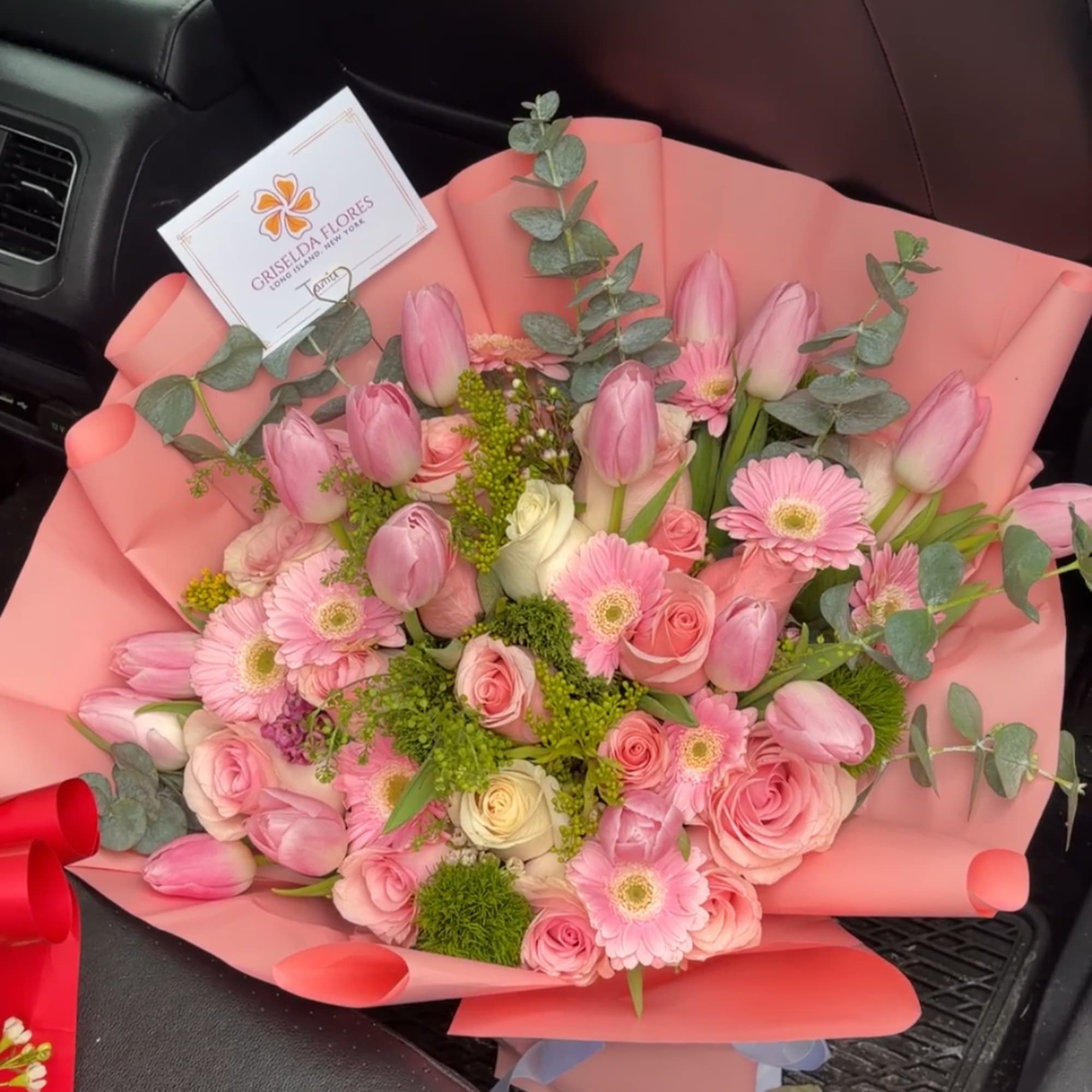 Pink tulips, roses, and gerbera daisies wrapped in pink paper