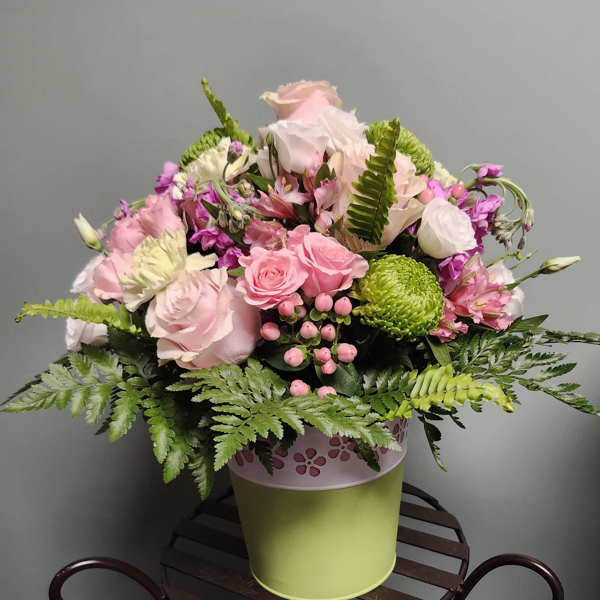 The striking green, and white tin has a contrasting pink floral cutout.