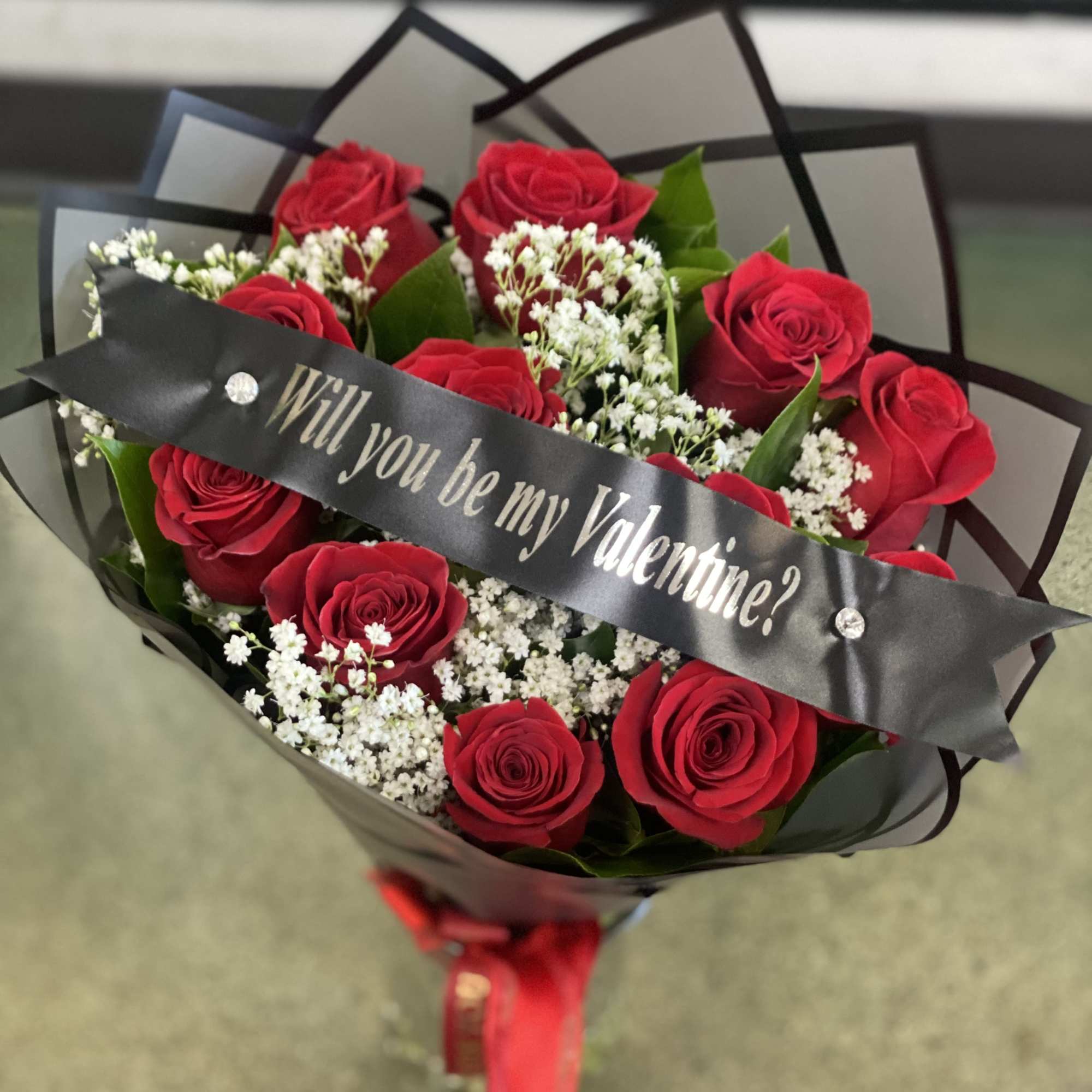 Bouquet of red roses with a Valentine ribbon