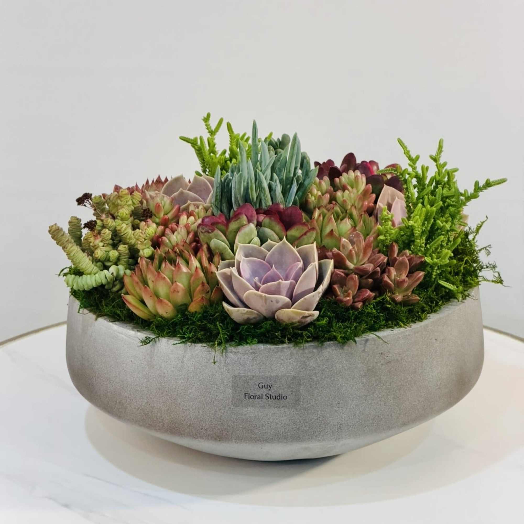 Bring a modern, elegant touch to any space with this handcrafted succulent
