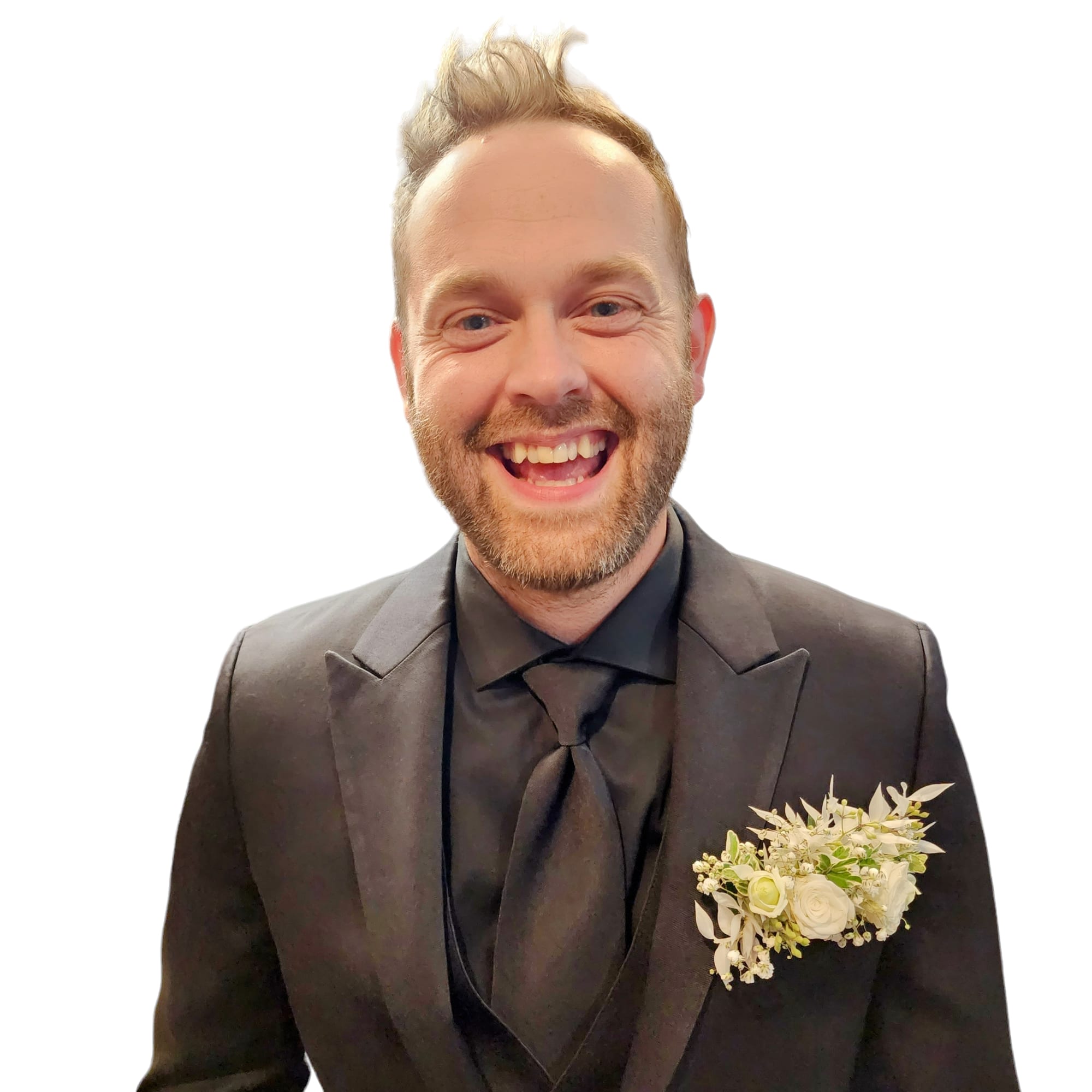 Man in a black suit with a white boutonniere on the lapel