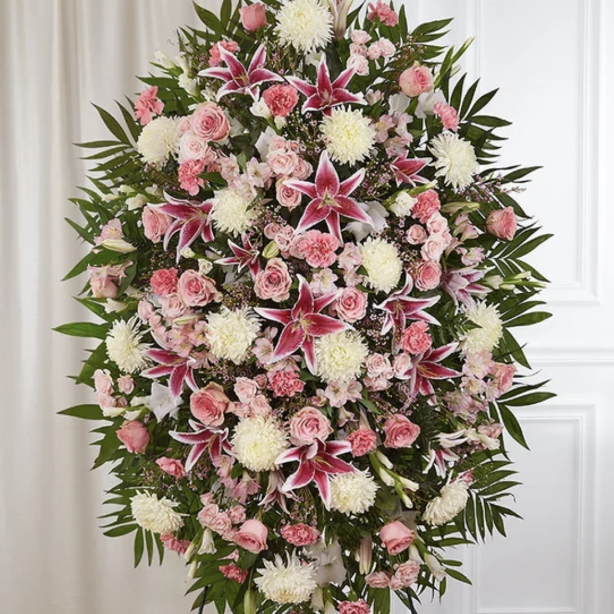 A graceful standing spray designed in all shades of pink, lavander and