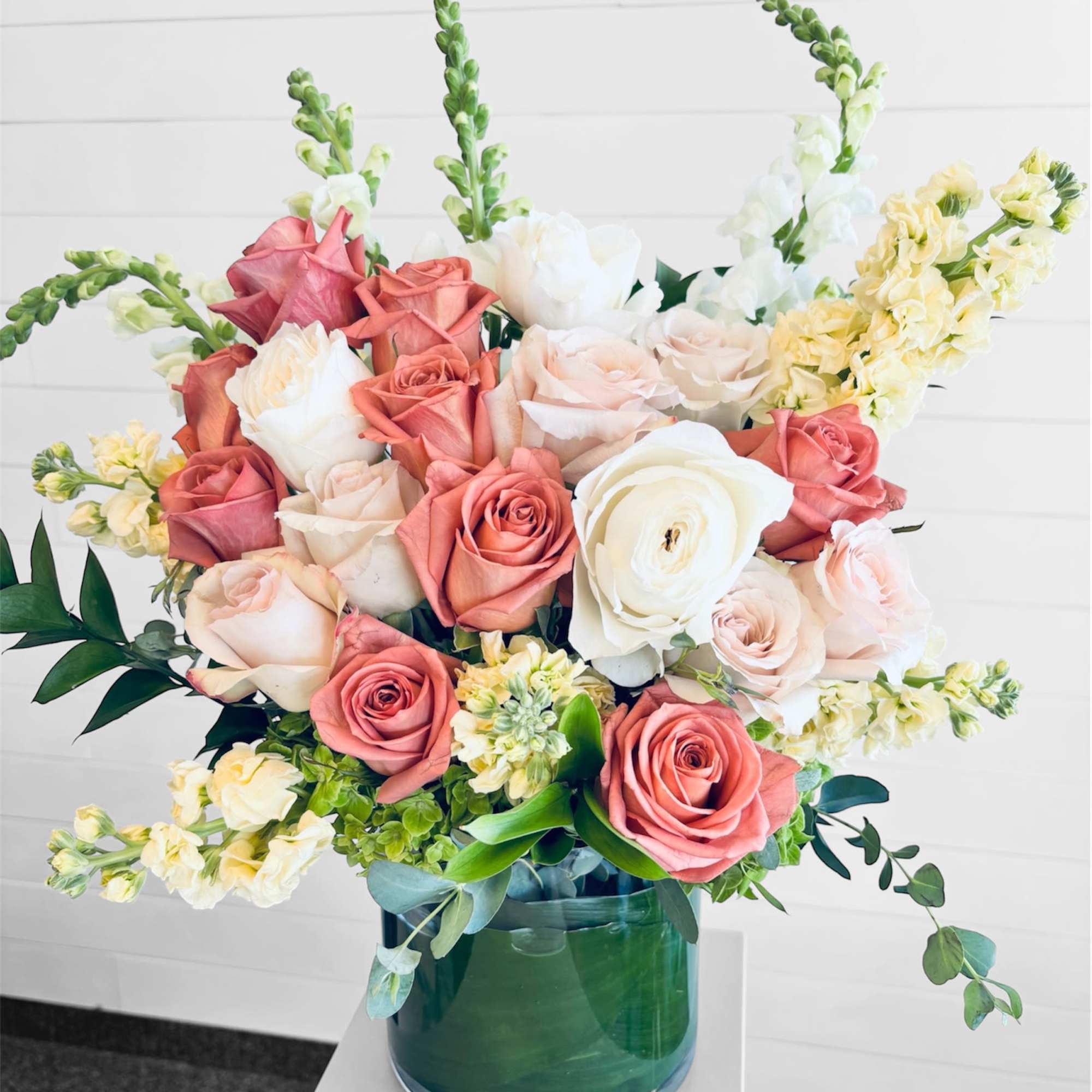Quiet Grace features premium roses and seasonal blooms in soft blush, ivory