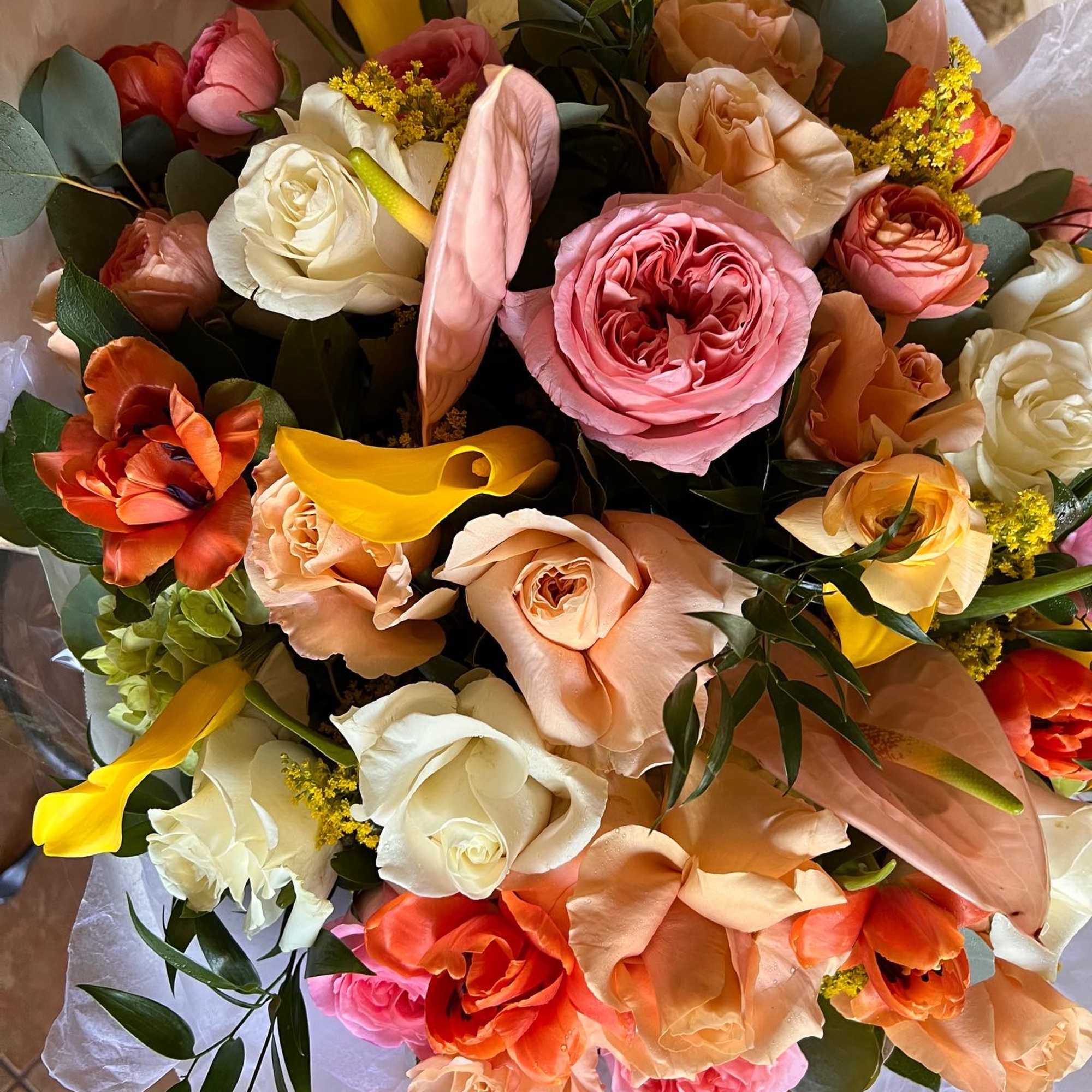 Bouquet of pink, peach, white, and orange flowers with yellow accents