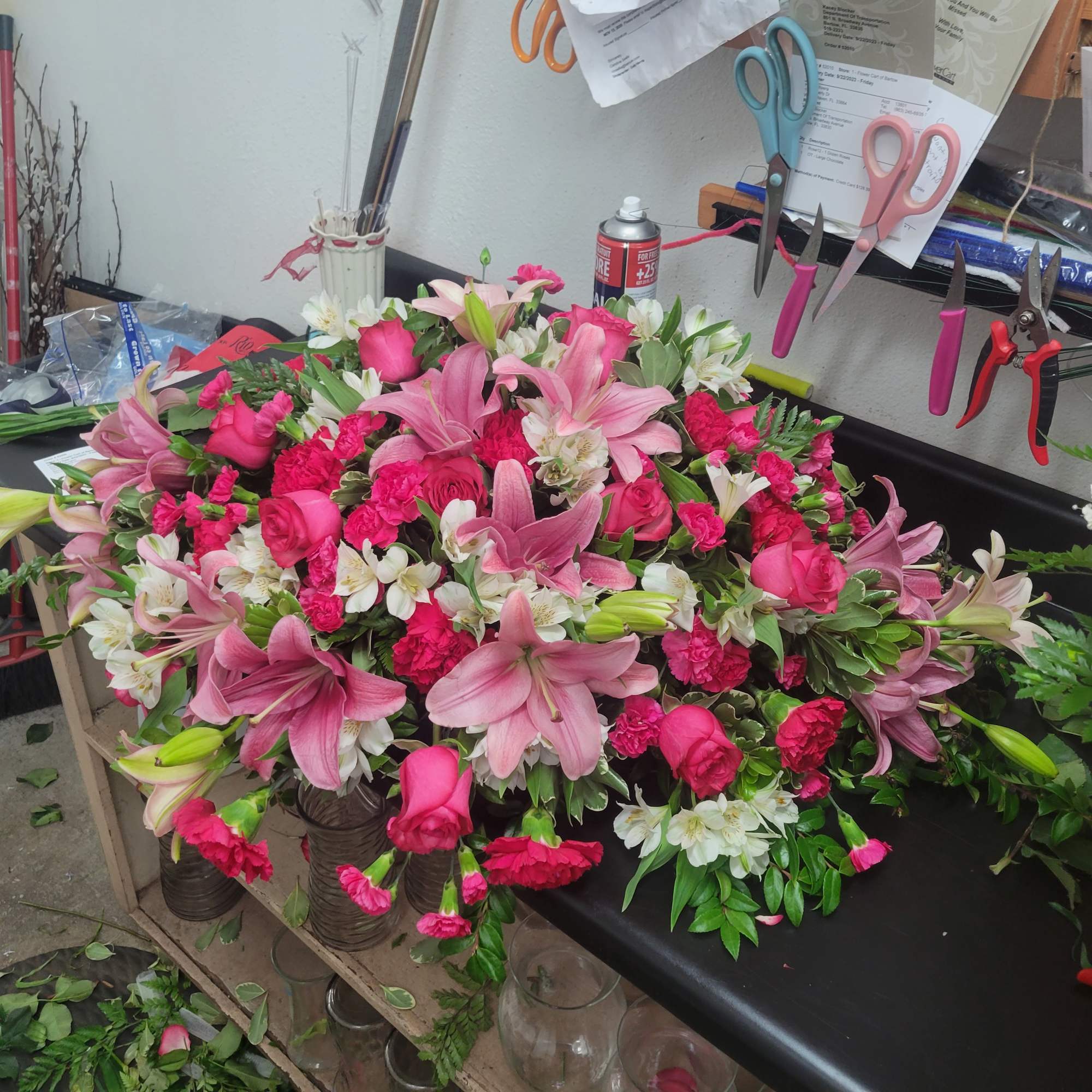 Large pink floral arrangement with lilies, roses, carnations, and white alstroemeria