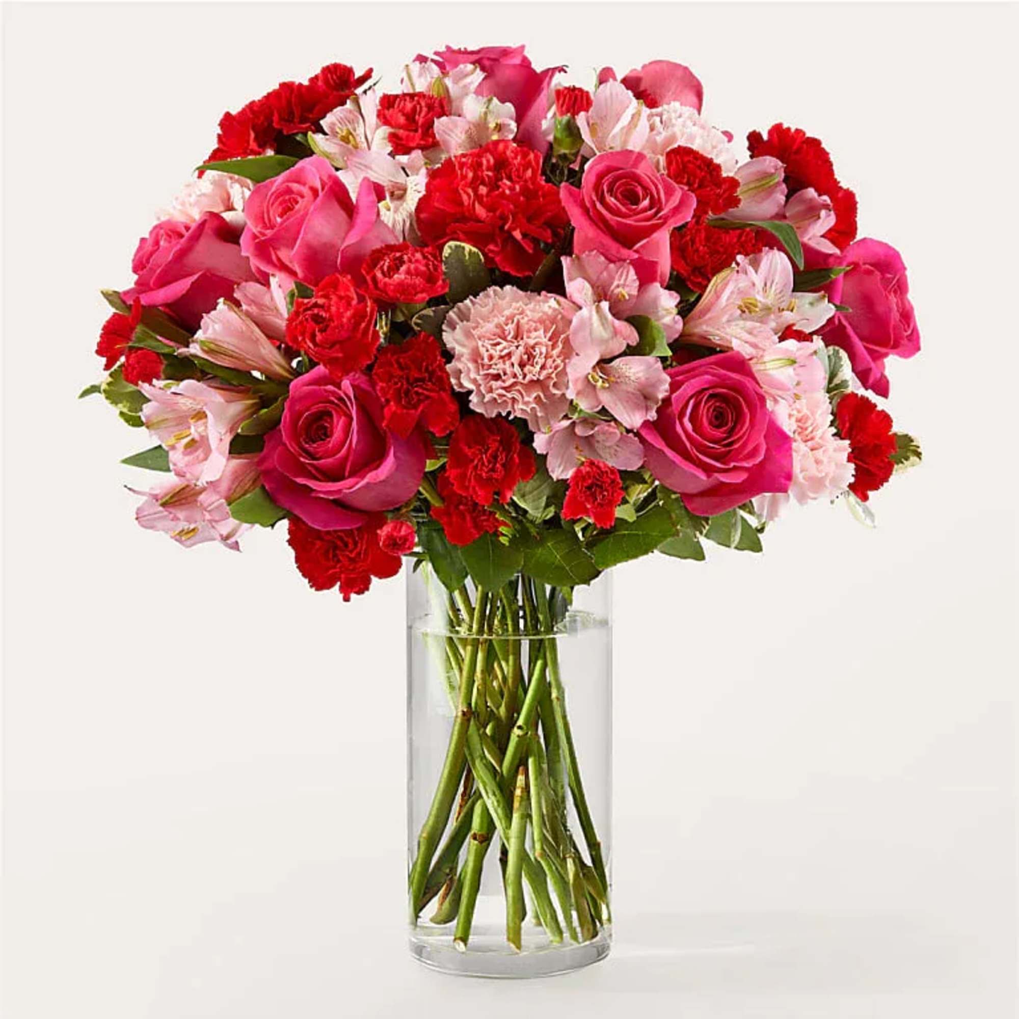 Pink and red mixed bouquet in a clear glass vase