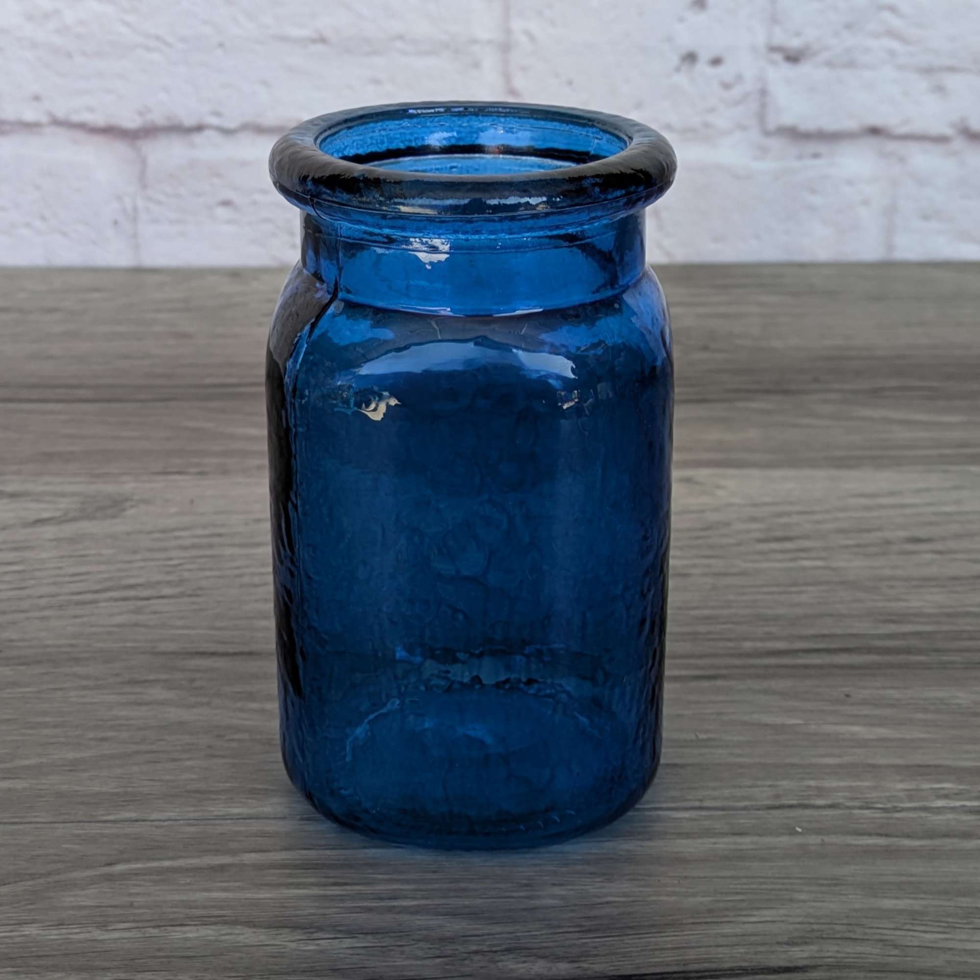Blue glass vase on a wooden surface