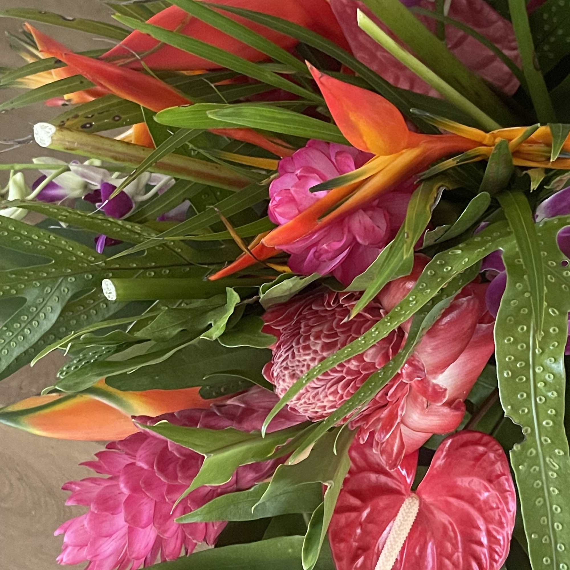 Mixed tropical bouquet with cottage blooms, and exotic foliage 