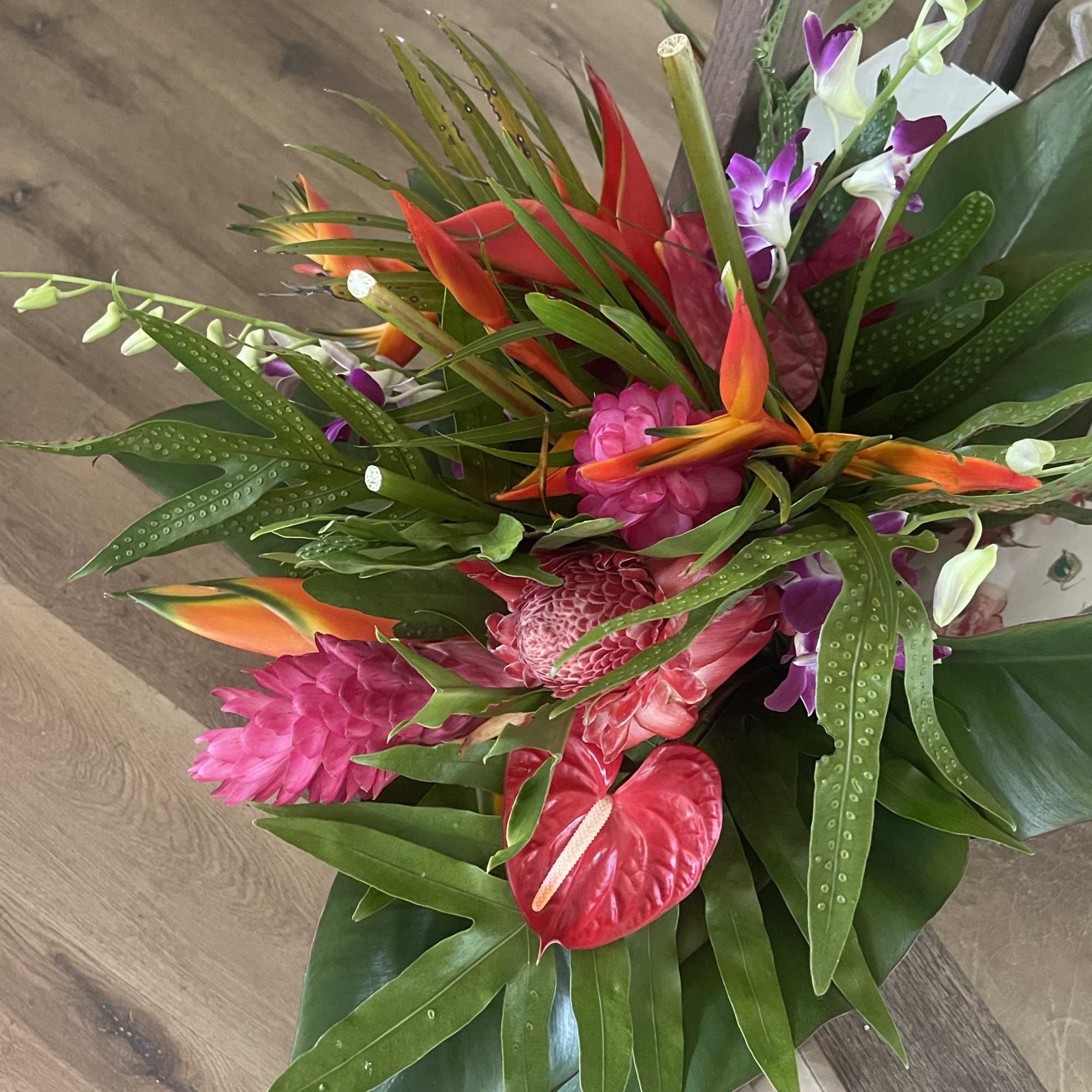 Mixed tropical bouquet with cottage blooms, and exotic foliage 