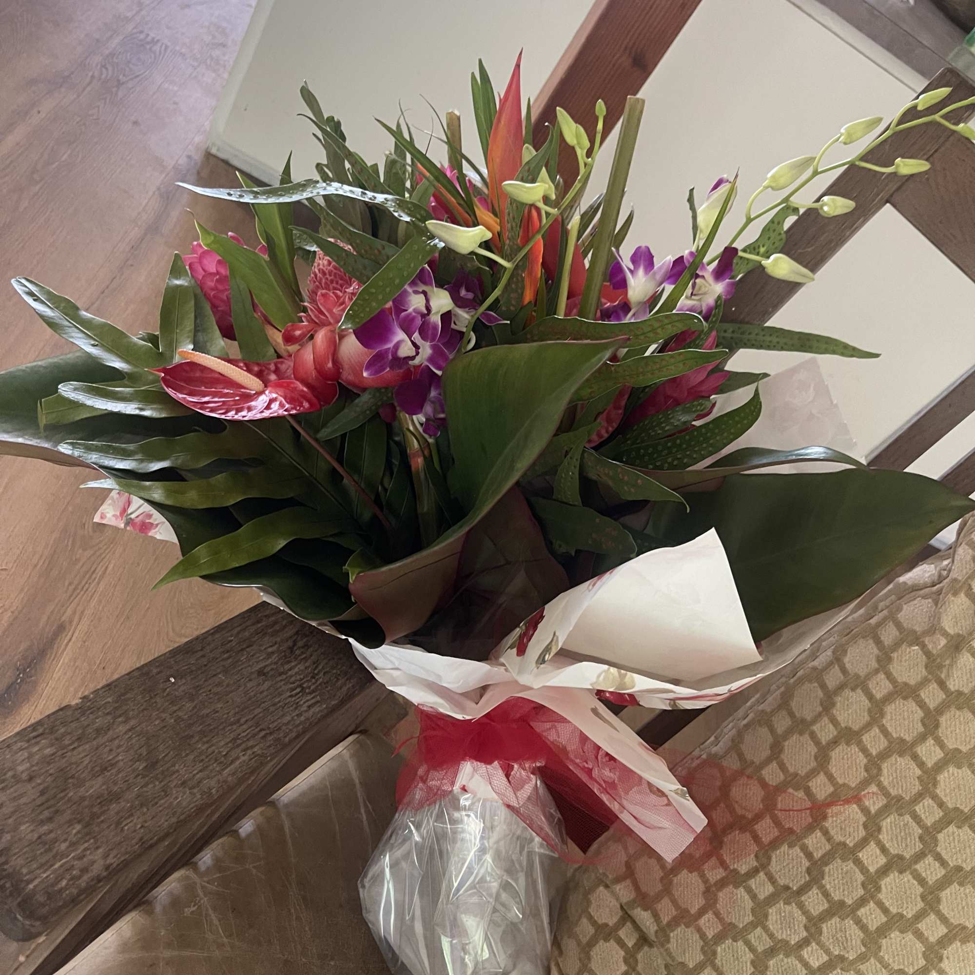 Mixed tropical bouquet with cottage blooms, and exotic foliage 