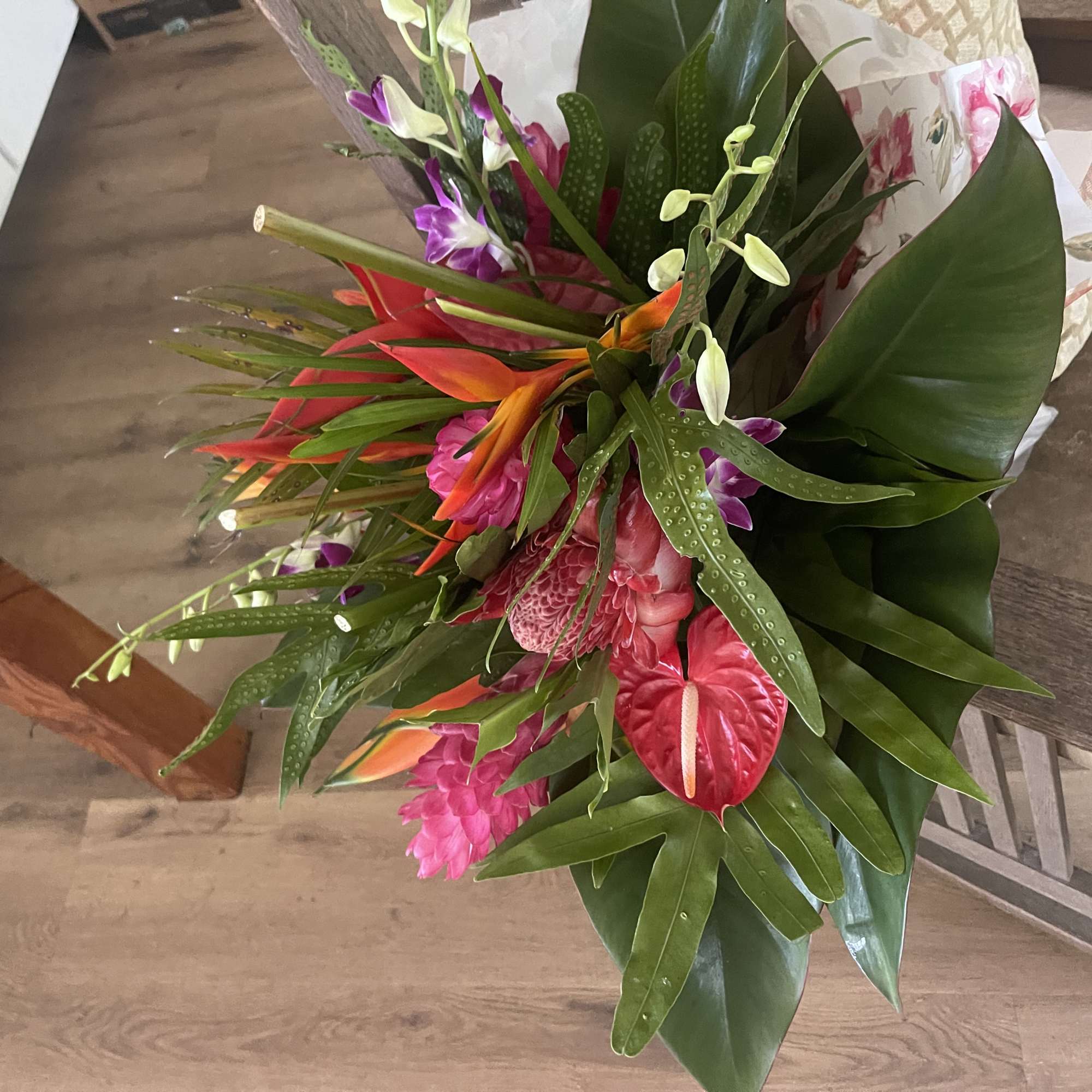 Mixed tropical bouquet with cottage blooms, and exotic foliage 