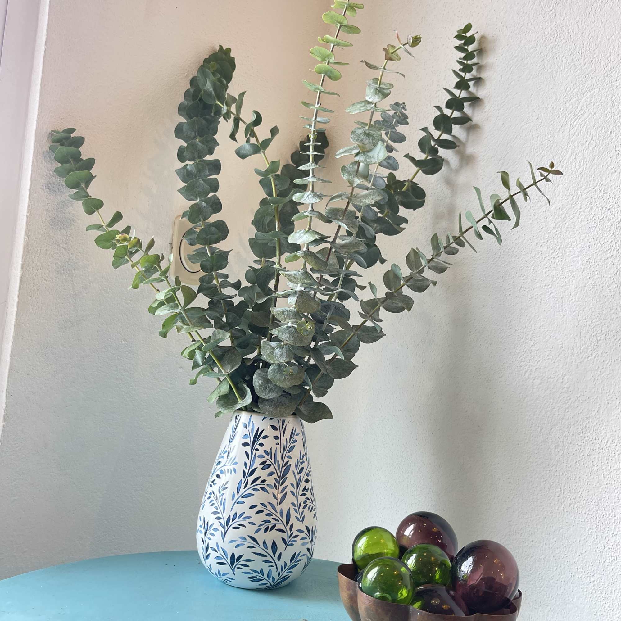A large bunch of eucalyptus in a vase