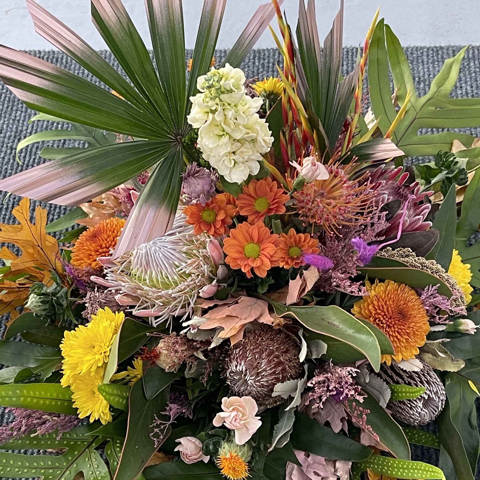 A premium selection of autumn inspired fall colored blooms and greenery A