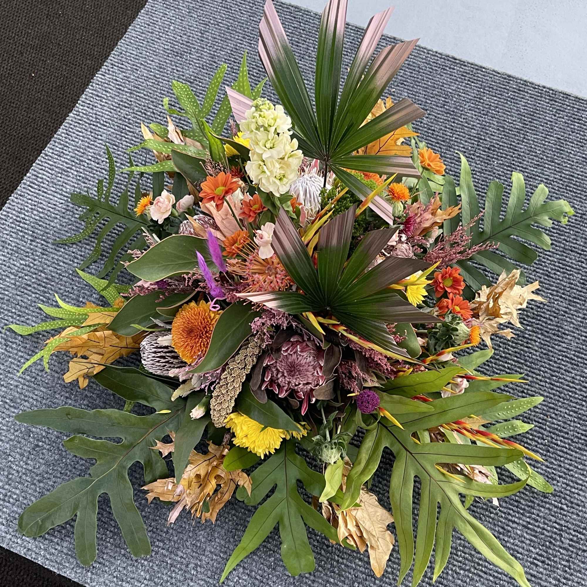 A premium selection of autumn inspired fall colored blooms and greenery A