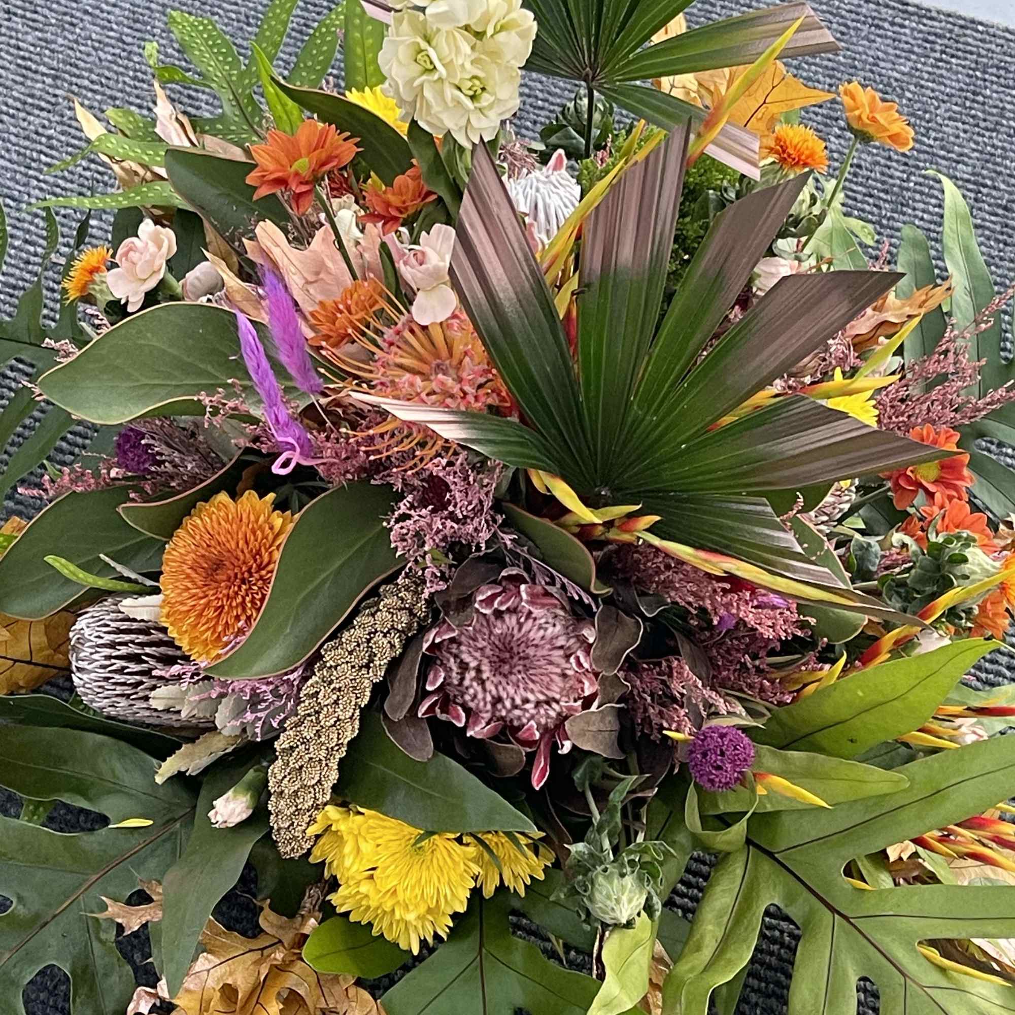 A premium selection of autumn inspired fall colored blooms and greenery A
