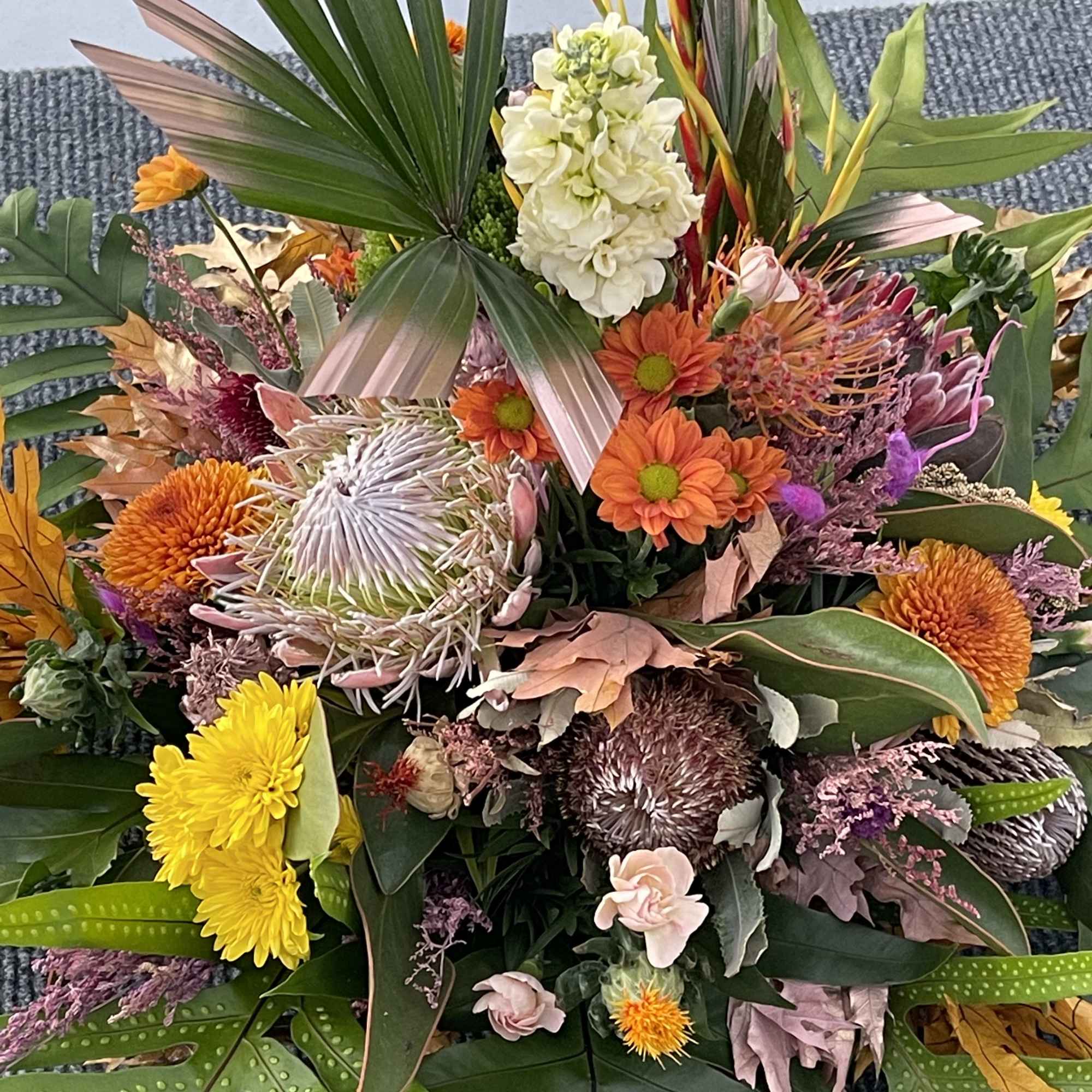 A premium selection of autumn inspired fall colored blooms and greenery A