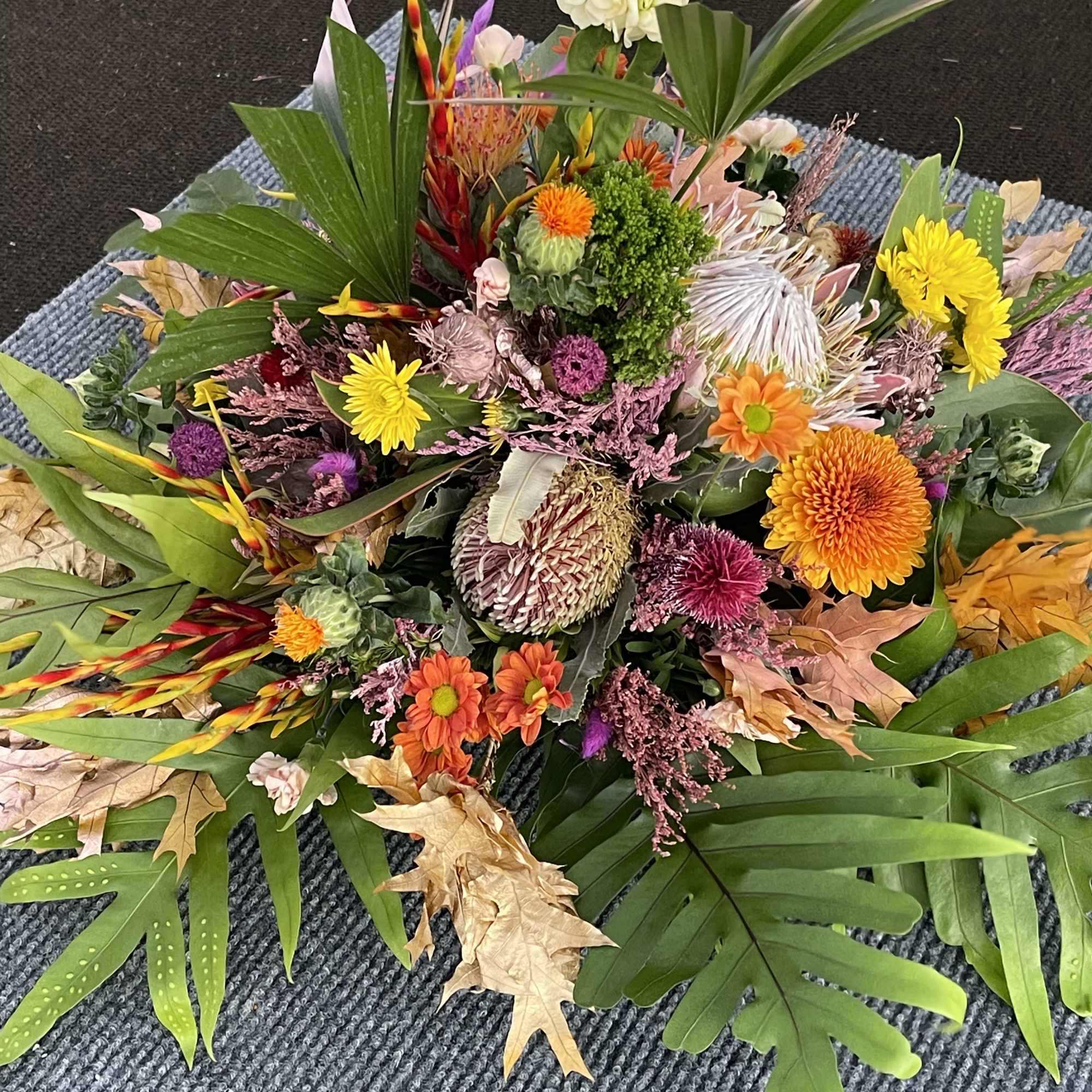 A premium selection of autumn inspired fall colored blooms and greenery A