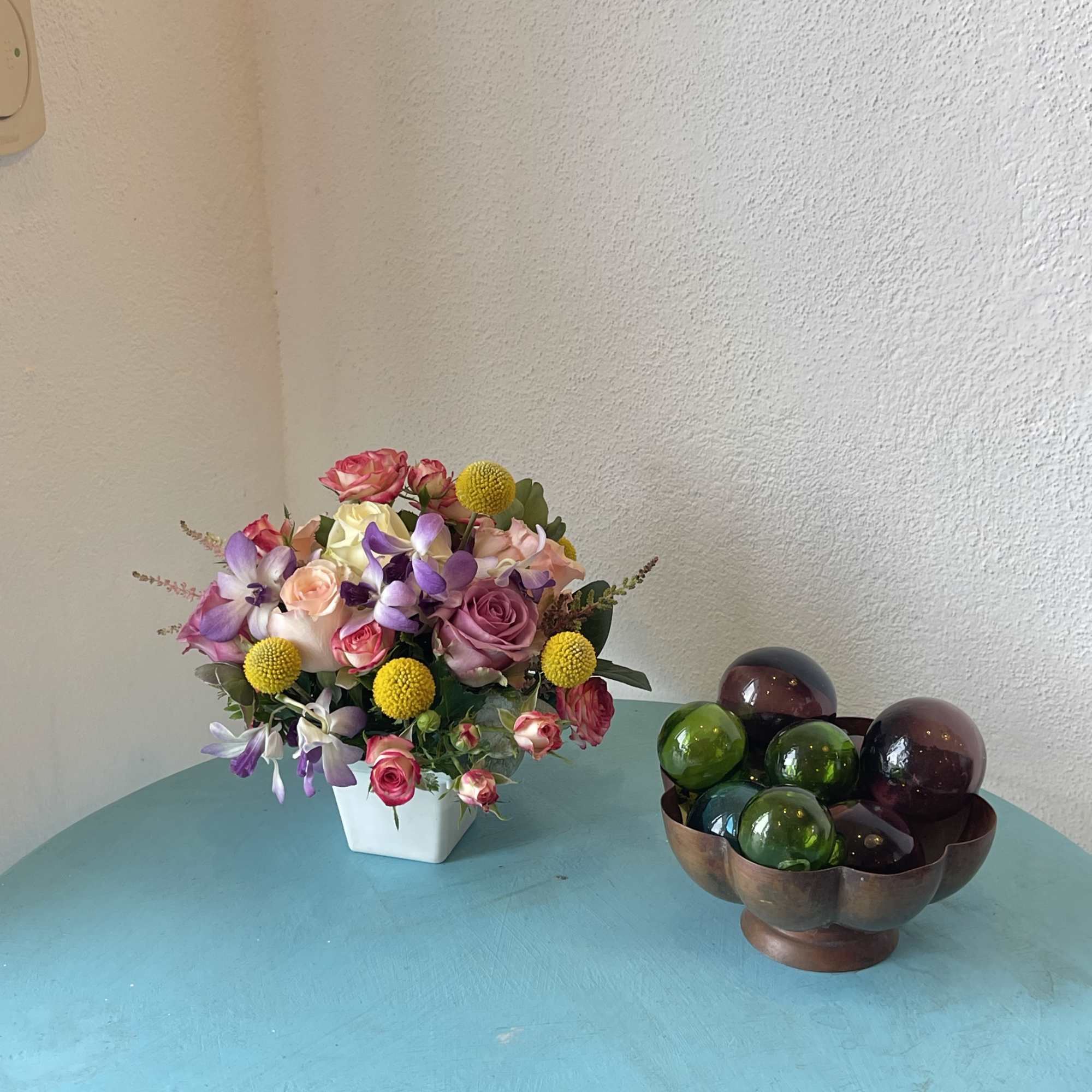 This centerpiece sensation displays a beautiful mix of roses and orchids with