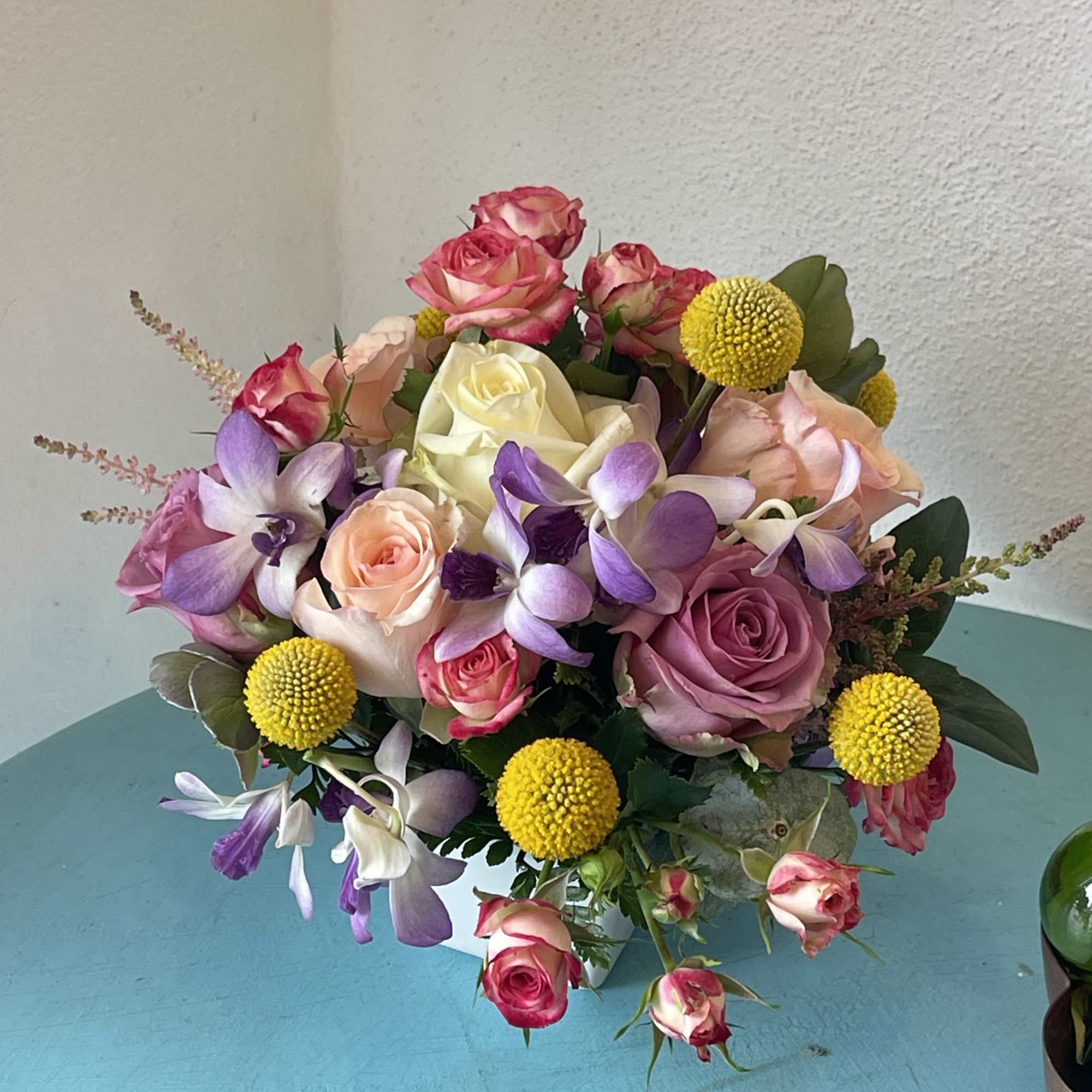 This centerpiece sensation displays a beautiful mix of roses and orchids with