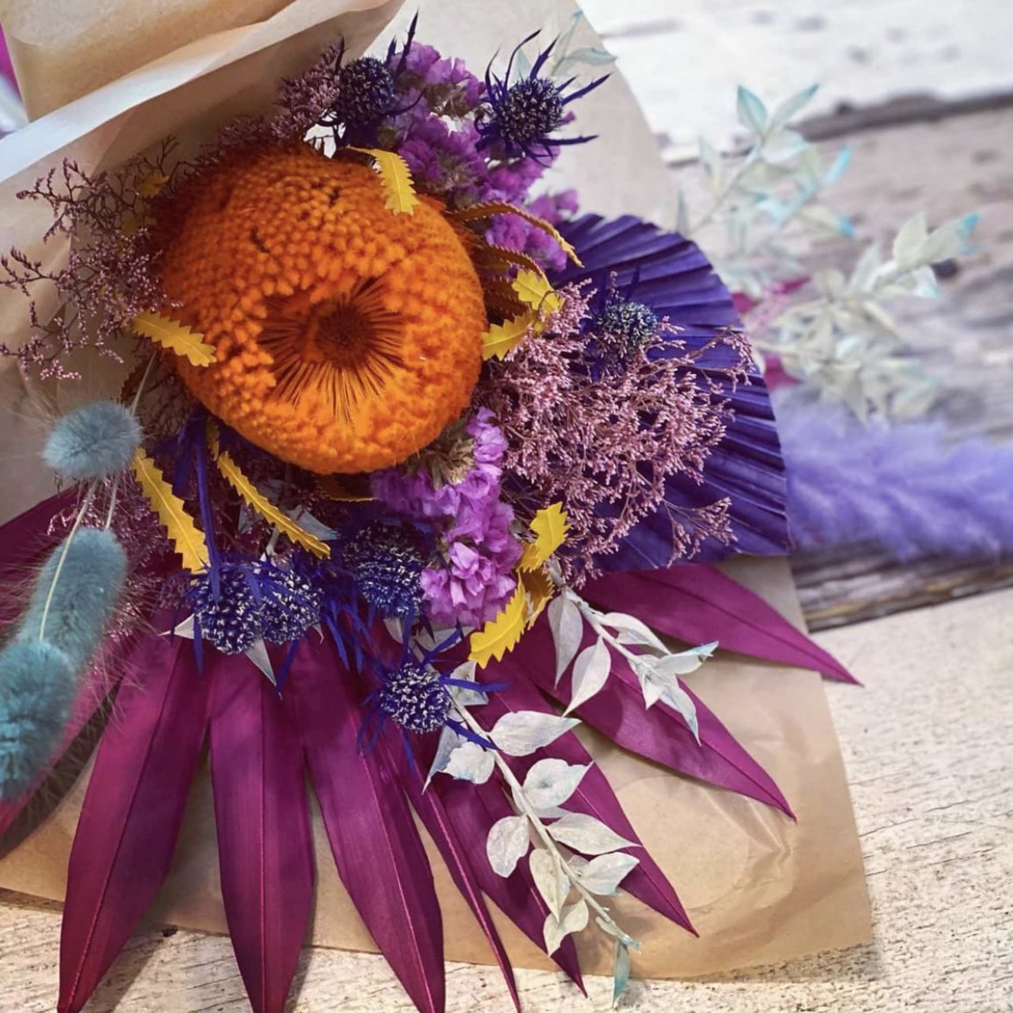 A colorful display of three #3 preserved floral bouquets 