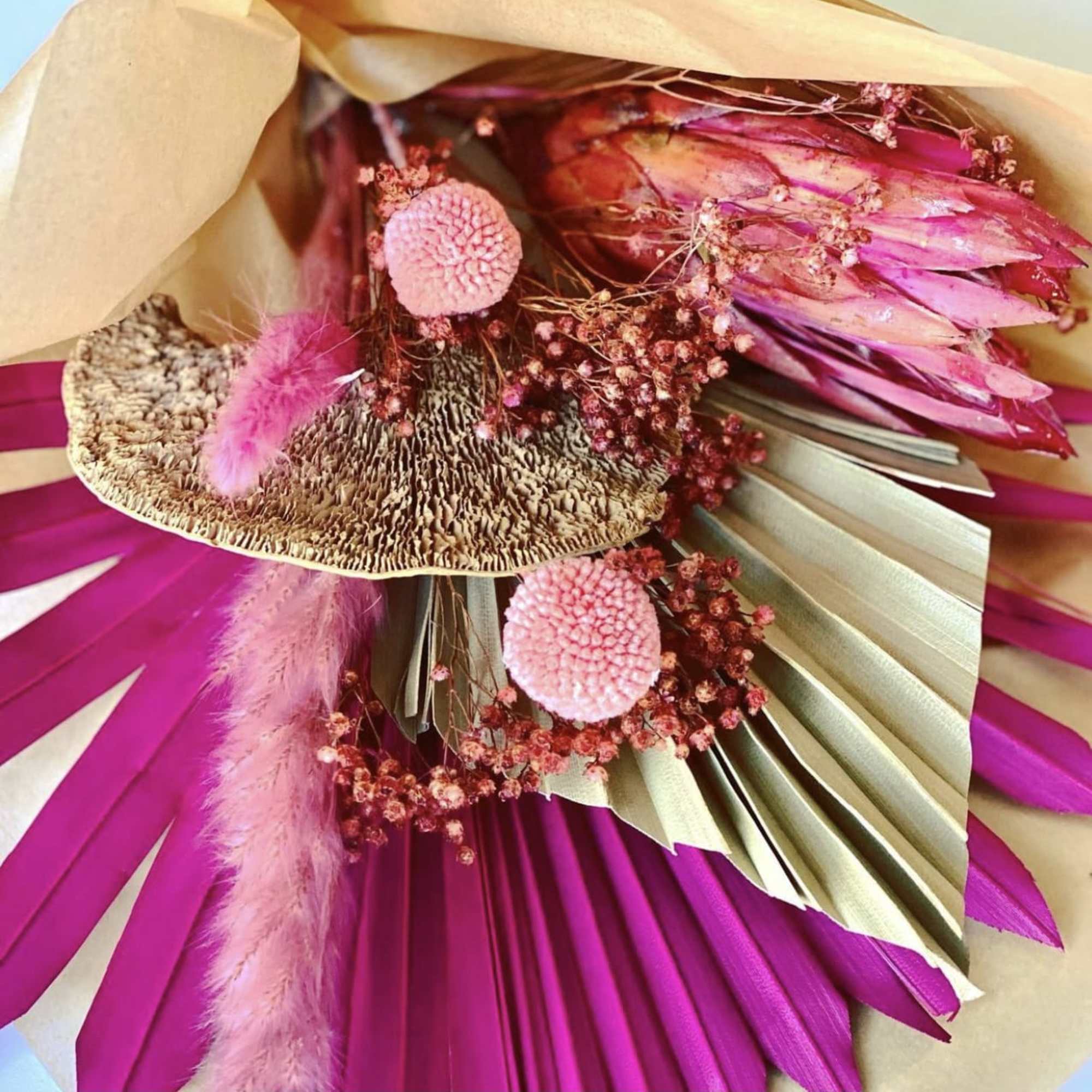 A colorful display of three #3 preserved floral bouquets 